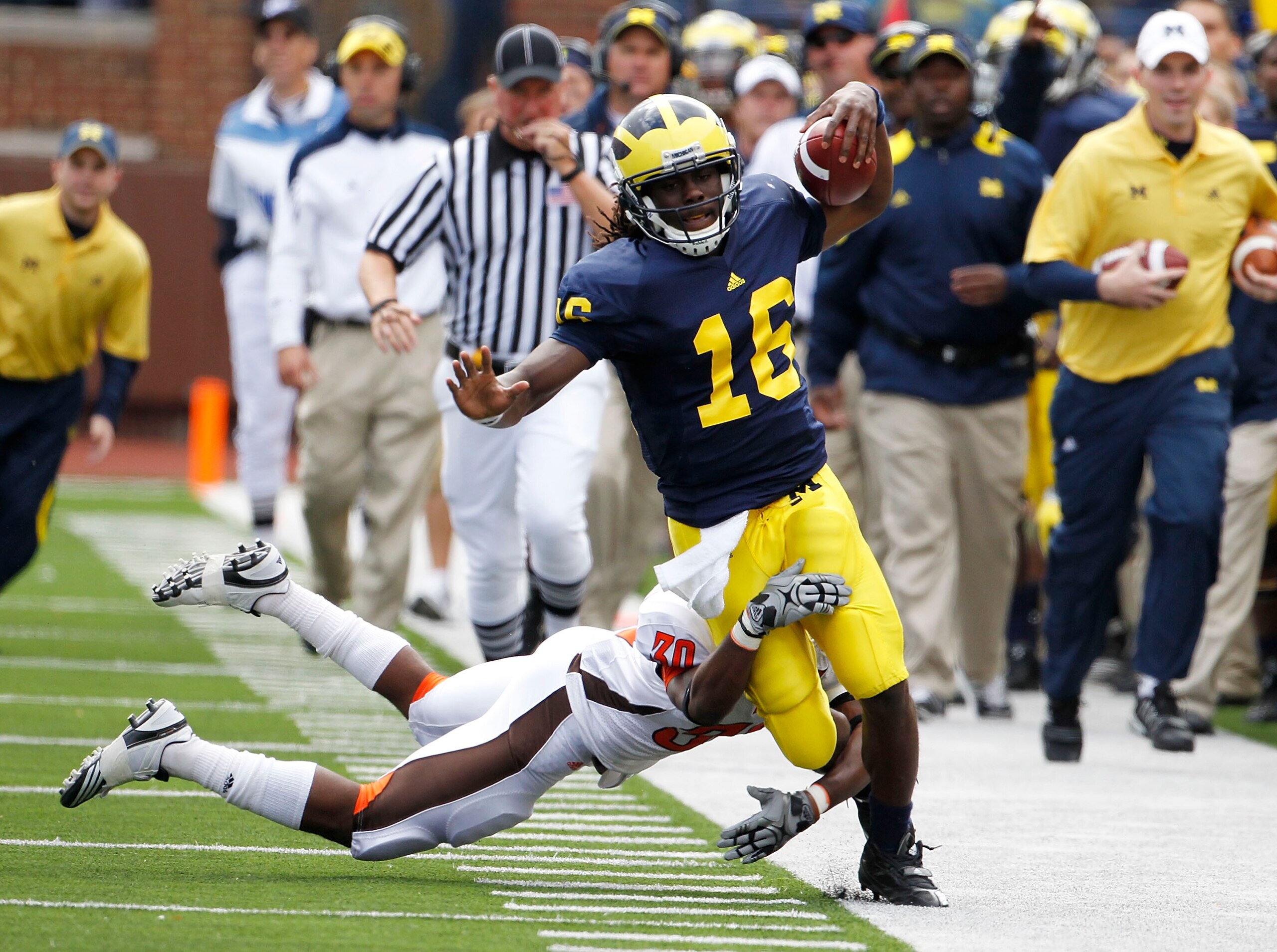 ANN ARBOR, MI - SEPTEMBER 25:  Cameron Truss #30 of Bowling Green tackles Denard Robison #16 of the Michigan Wolverines on September 25, 2010 at Michigan Stadium in Ann Arbor, Michigan. Robison left the game after this play with a reported leg injury.  (P