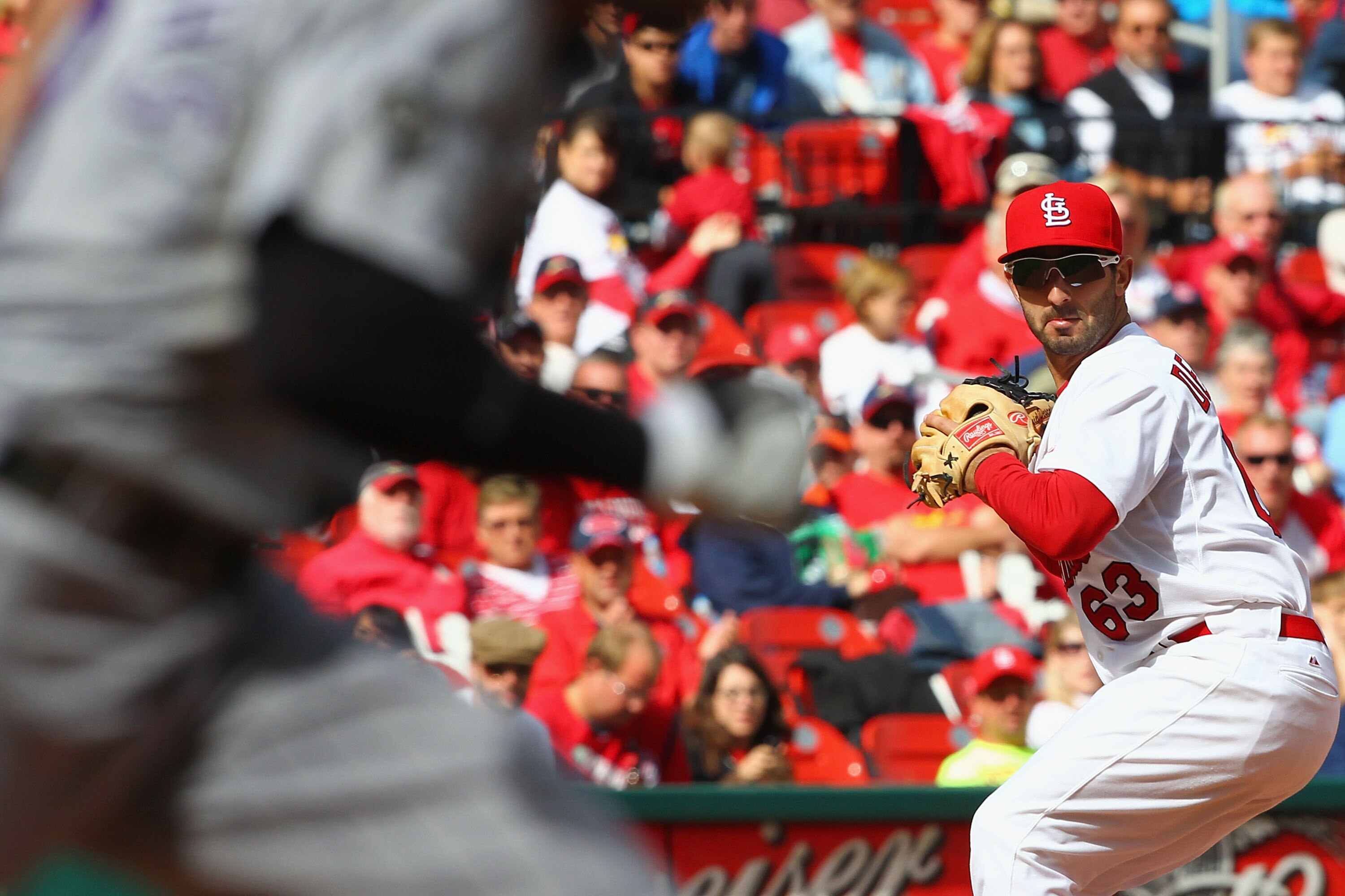 ST. LOUIS - OCTOBER 2:  Daniel Descalso #63 of the St. Louis Cardinals throws to first base against the Colorado Rockies at Busch Stadium on October 2, 2010 in St. Louis, Missouri.  The Cardinals beat the Rockies 1-0 in 11 innings.  (Photo by Dilip Vishwa