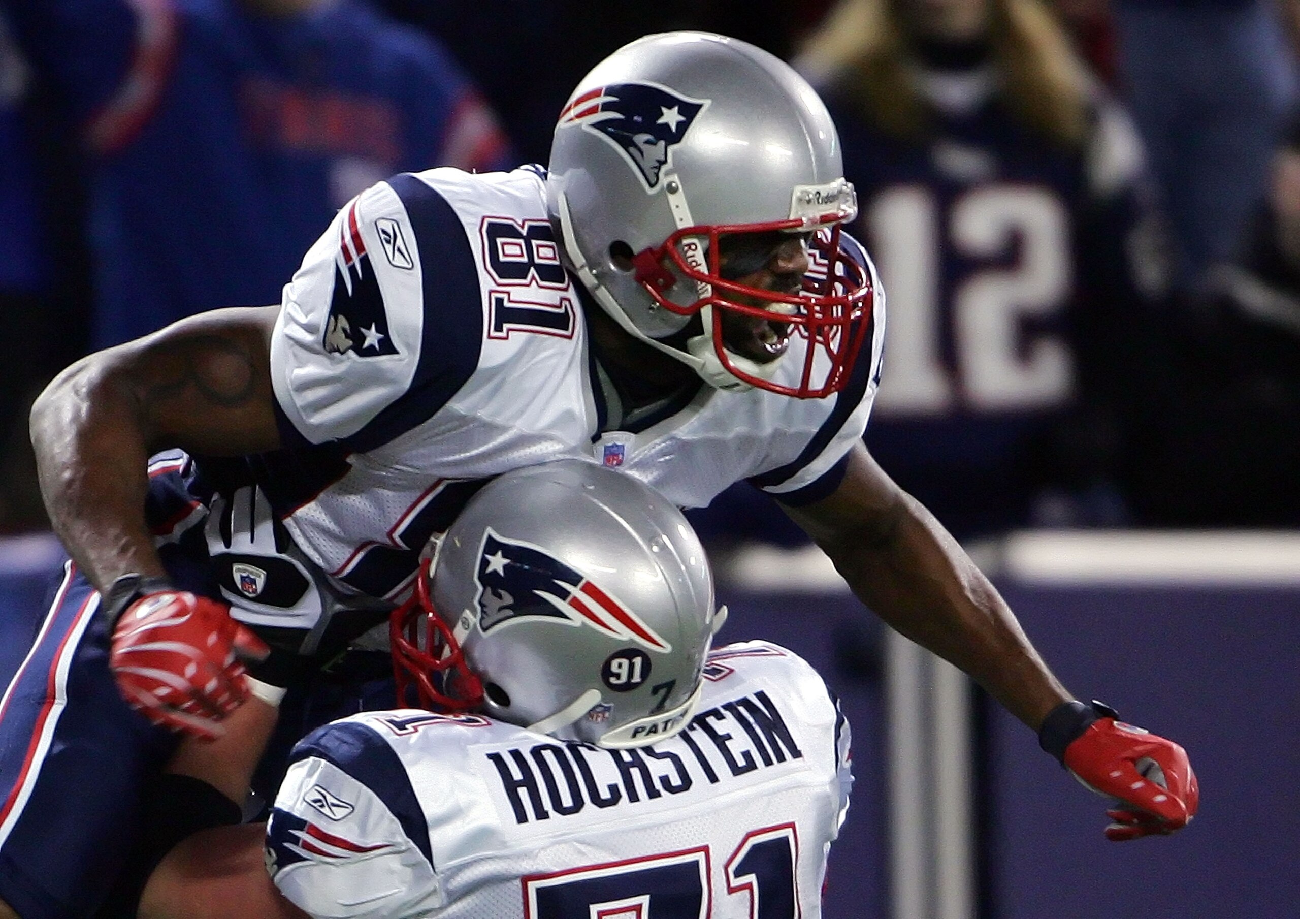 EAST RUTHERFORD, NJ - DECEMBER 29:  Randy Moss  #81 of the New England Patriots celebrates his 22nd touchdown of the season tying the all-time season high for touchdowns in a season with teammate Russ Hochstein #71 against the New York Giants on December