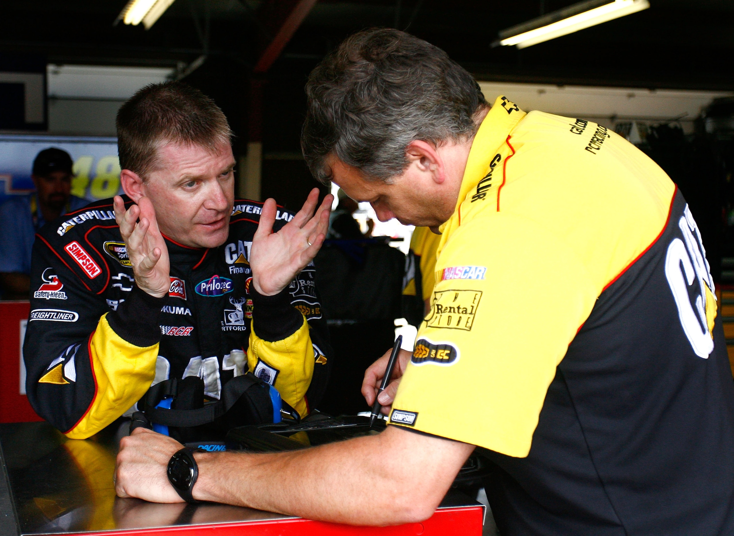 BROOKLYN, MI - JUNE 12:  Jeff Burton (L), driver of the #31 Caterpillar Chevrolet speaks with crew chief Todd Berrier (R) during practice for the NASCAR Sprint Cup Series Heluva Good! Sour Cream Dips 400 at Michigan International Speedway on June 12, 2010