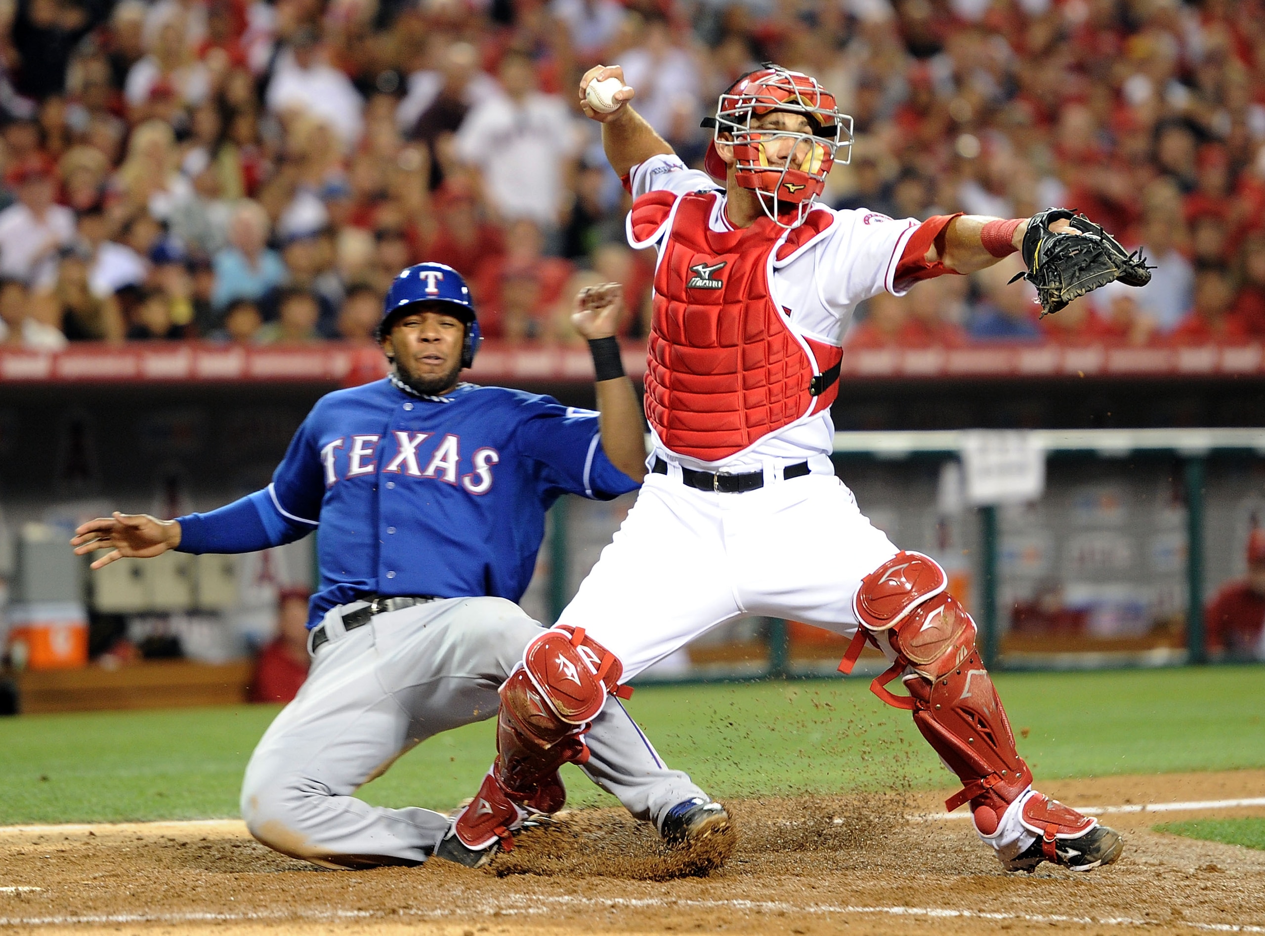 ANAHEIM, CA - JUNE 29:  Jeff Mathis #5 of the Los Angeles Angels forces out Elvis Andrus #1 of the Texas Rangers as he throws to first base during the fifth inning at Angel Stadium on June 29, 2010 in Anaheim, California.  (Photo by Harry How/Getty Images