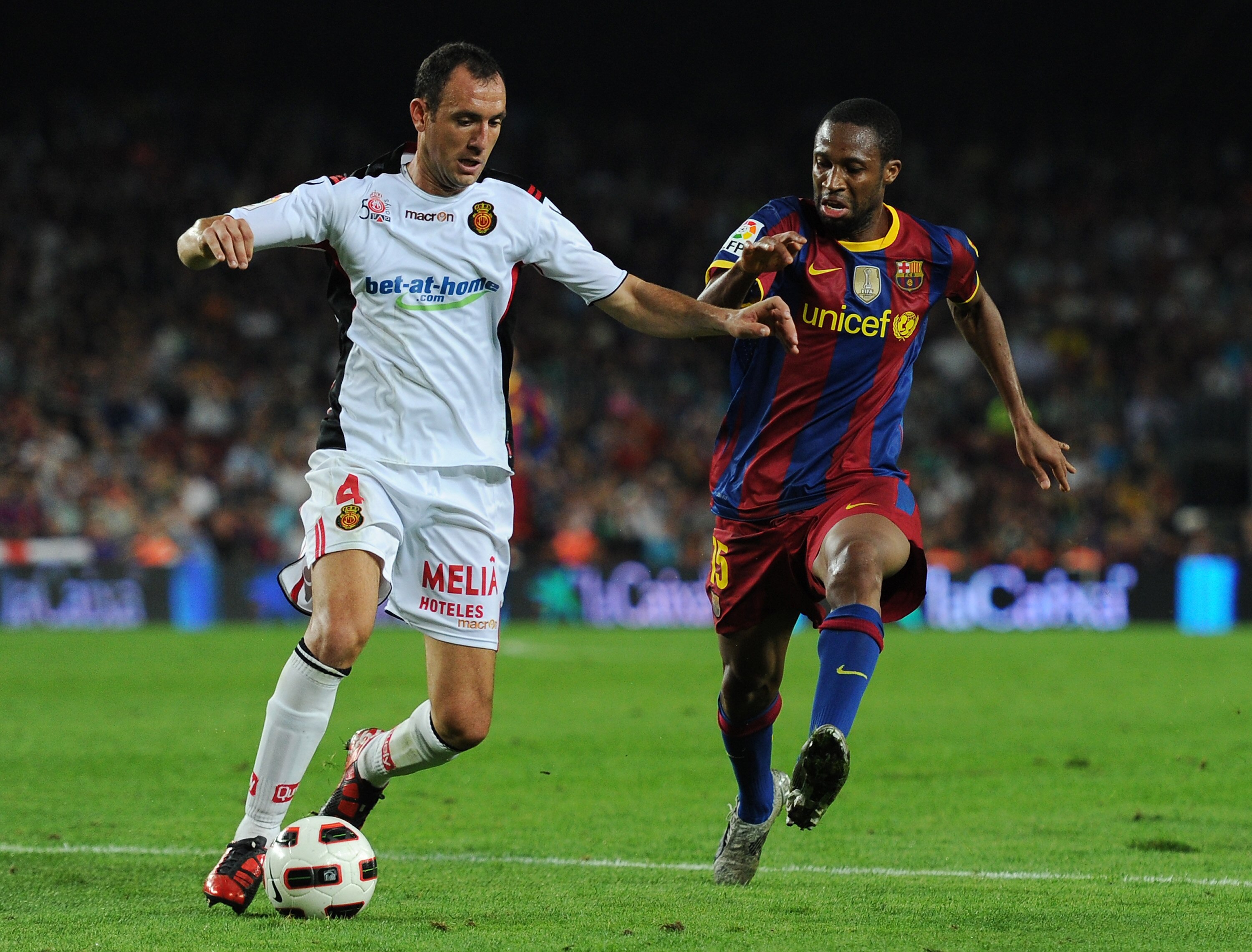 BARCELONA, SPAIN - OCTOBER 03:  Seydou Keita (R) of Barcelona duels for the ball with Ivan Ramis of Mallorca during the La Liga match between Barcelona and Mallorca at the Camp Nou stadium on October 3, 2010 in Barcelona, Spain. The match ended in a 1-1 d