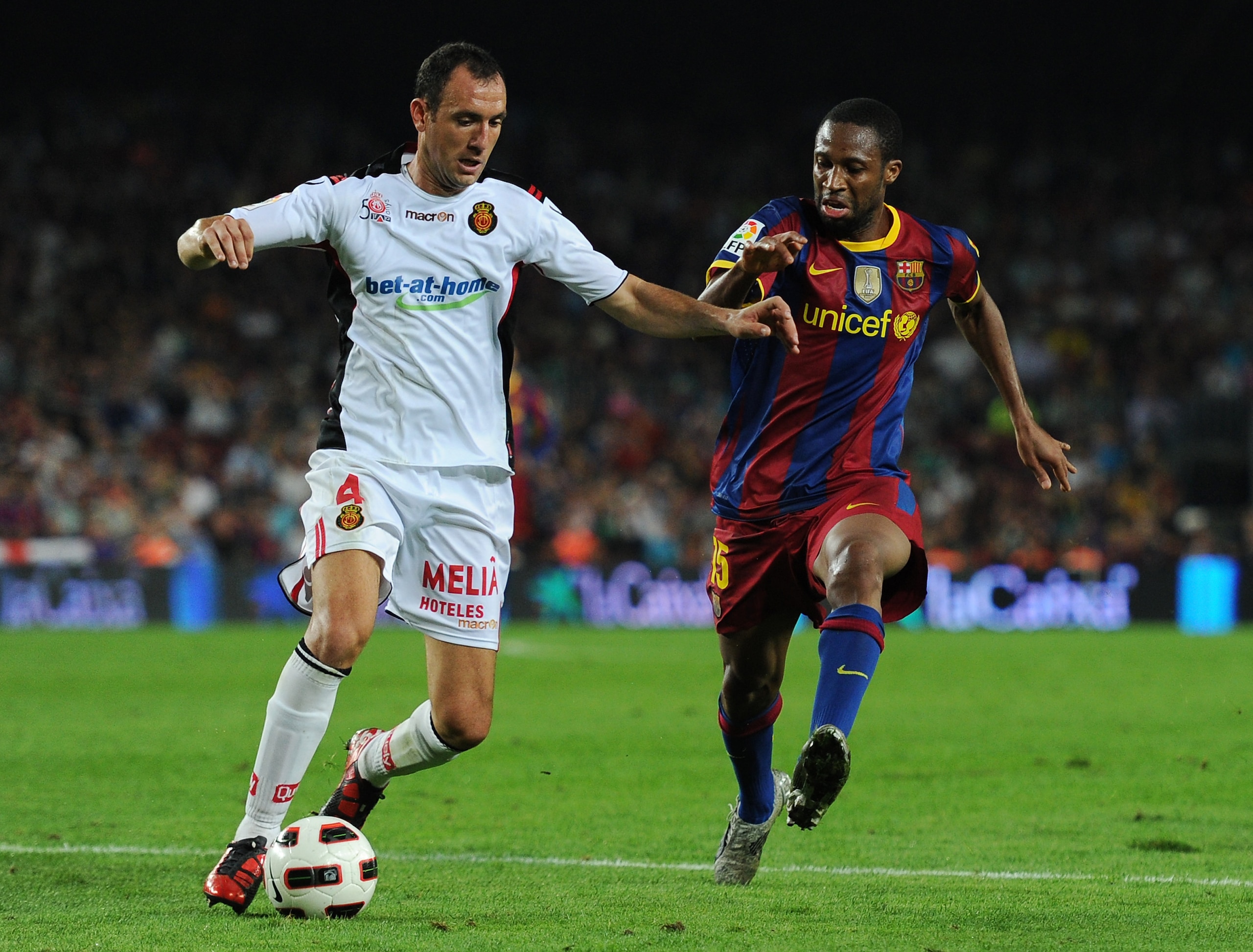 BARCELONA, SPAIN - OCTOBER 03:  Seydou Keita (R) of Barcelona duels for the ball with Ivan Ramis of Mallorca during the La Liga match between Barcelona and Mallorca at the Camp Nou stadium on October 3, 2010 in Barcelona, Spain. The match ended in a 1-1 d