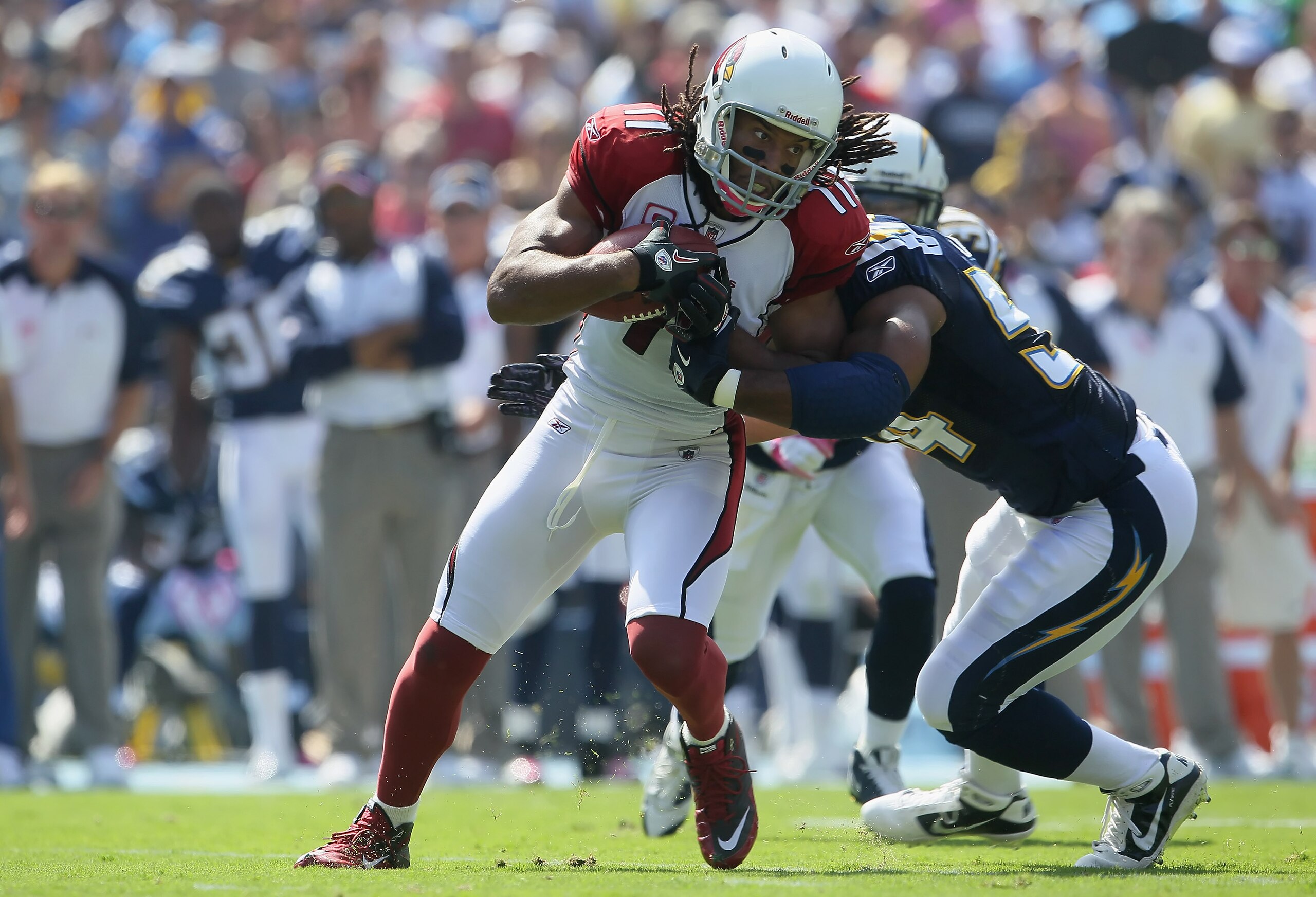 SAN DIEGO - OCTOBER 03:  Wide receiver Larry Fitzgerald #11 of the Arizona Cardinals is tackled by Stephen Cooper #54 of the San Diego Chargers after a reception in the first quarter at Qualcomm Stadium on October 3, 2010 in San Diego, California. The Cha