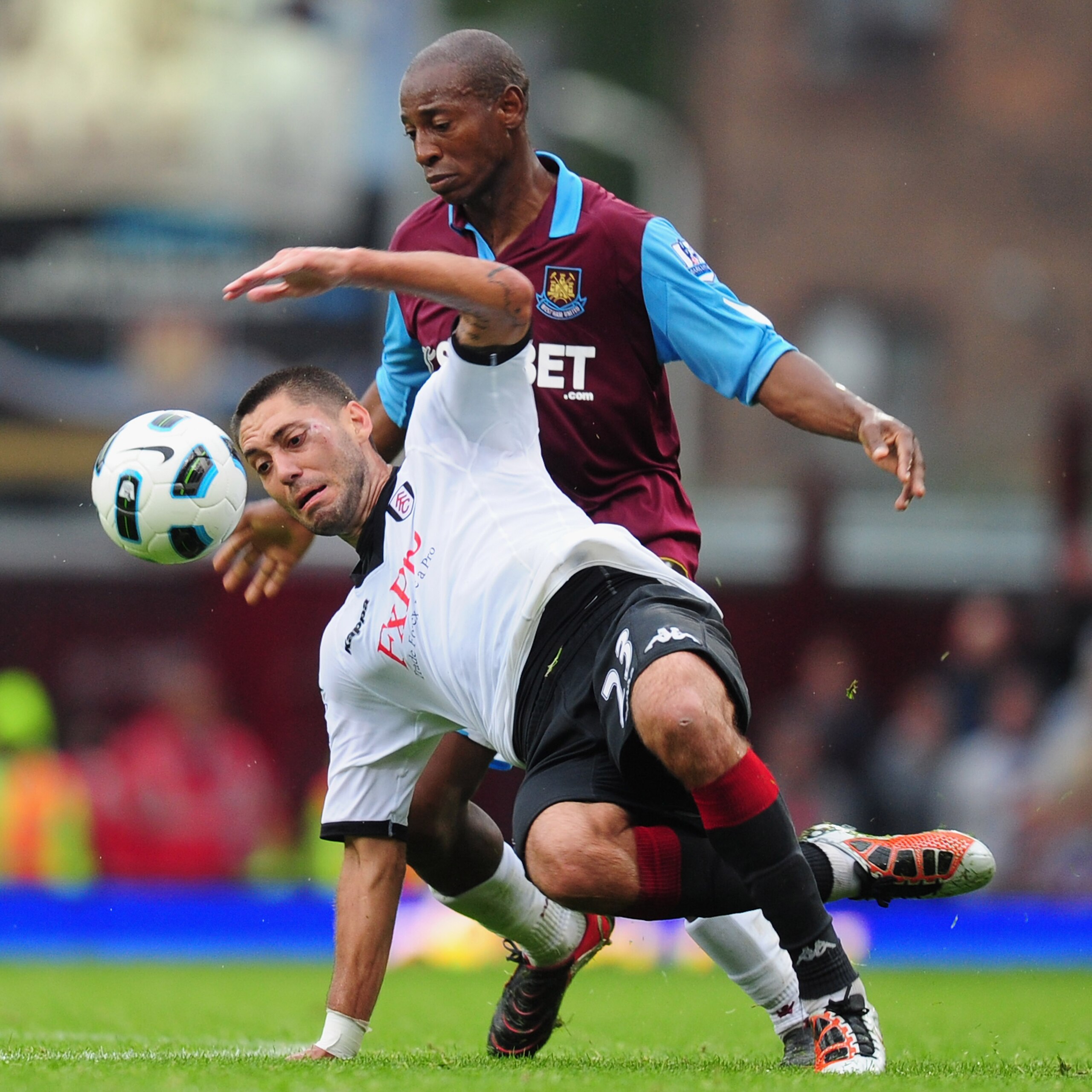 LONDON, ENGLAND - OCTOBER 02:  Clint Dempsey of Fulham is challenged by Luis Boa Morte of West Ham during the Barclays Premier League match between West Ham United and Fulham at Boleyn Ground on October 2, 2010 in London, England.  (Photo by Mike Hewitt/G