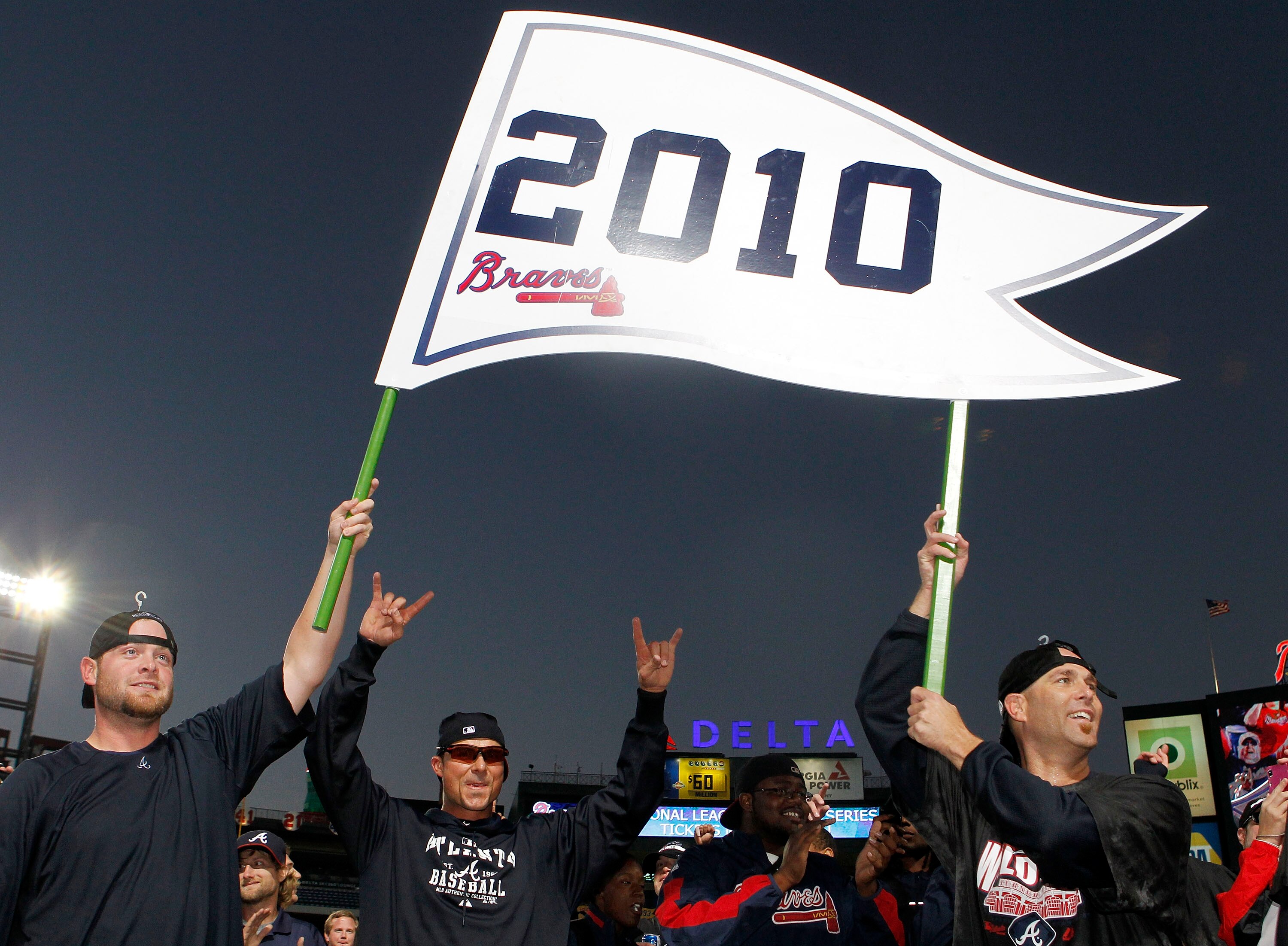 ATLANTA - OCTOBER 3:  Catcher Brian McCann #16 and pitcher Tim Hudson #15 of the Atlanta Braves hold up a 2010 playoff banner during the on-field celebration after the game against the Atlanta Braves Philadelphia Phillies at Turner Field on October 3, 201