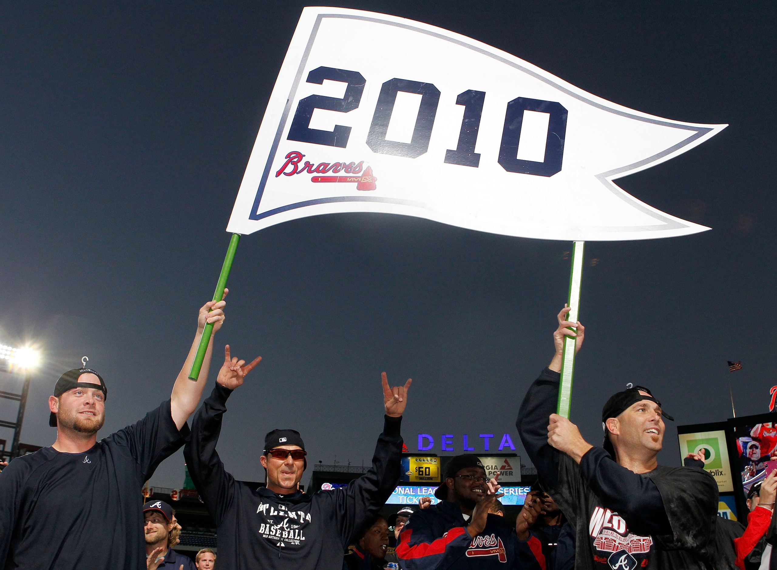 ATLANTA - OCTOBER 3:  Catcher Brian McCann #16 and pitcher Tim Hudson #15 of the Atlanta Braves hold up a 2010 playoff banner during the on-field celebration after the game against the Atlanta Braves Philadelphia Phillies at Turner Field on October 3, 201