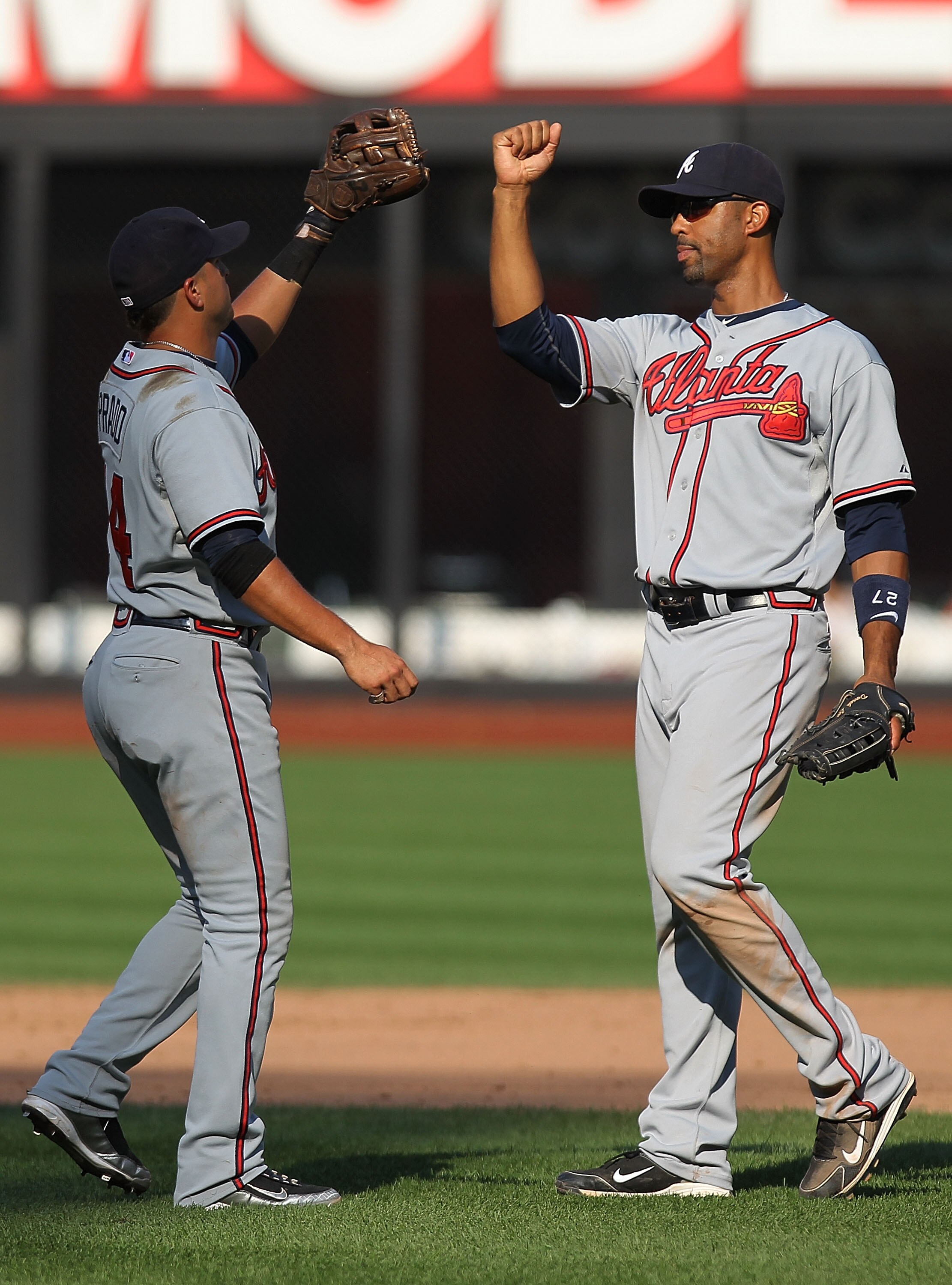 NEW YORK - SEPTEMBER 19: Derek Lee #27 of the Atlanta Braves celebrates the win with teammate Martin Prado #14 against the New York Mets at Citi Field on September 19, 2010 in the Flushing neighborhood of the Queens borough of New York City.  (Photo by Ni