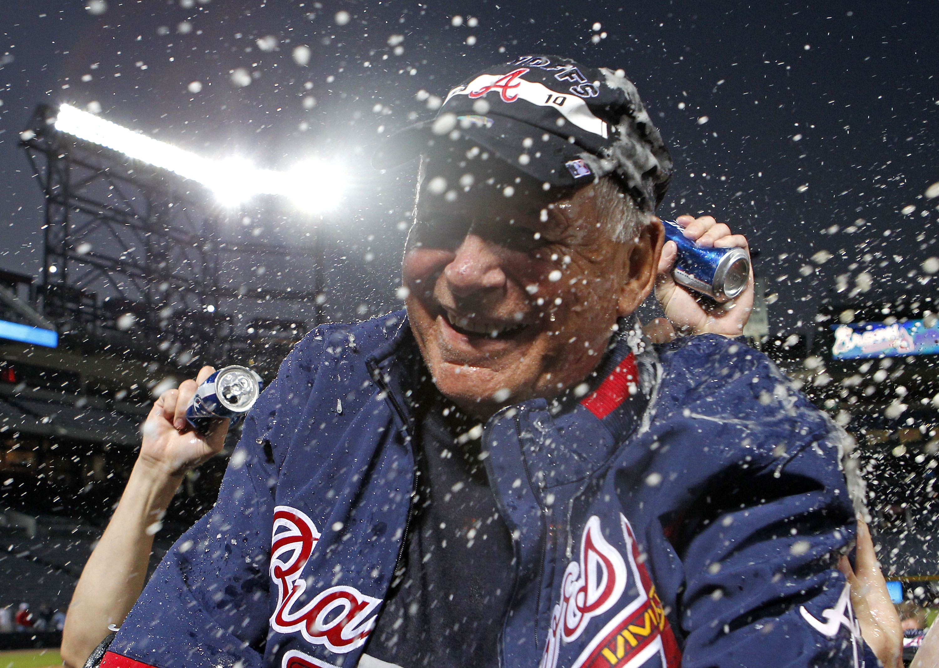 ATLANTA - OCTOBER 03:  Manager Bobby Cox #6 of the Atlanta Braves is doused by beer during the on-field playoff celebration after the game against the Philadelphia Phillies at Turner Field on October 3, 2010 in Atlanta, Georgia. The Braves beat the Philli