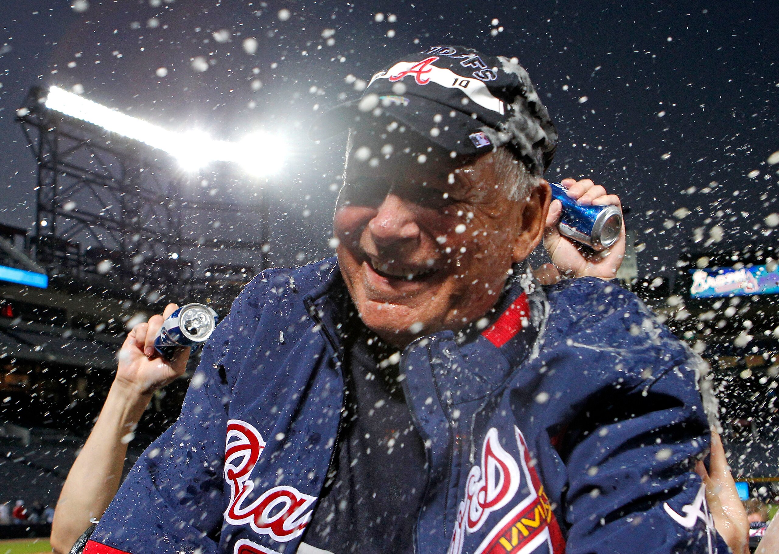 ATLANTA - OCTOBER 03:  Manager Bobby Cox #6 of the Atlanta Braves is doused by beer during the on-field playoff celebration after the game against the Philadelphia Phillies at Turner Field on October 3, 2010 in Atlanta, Georgia. The Braves beat the Philli