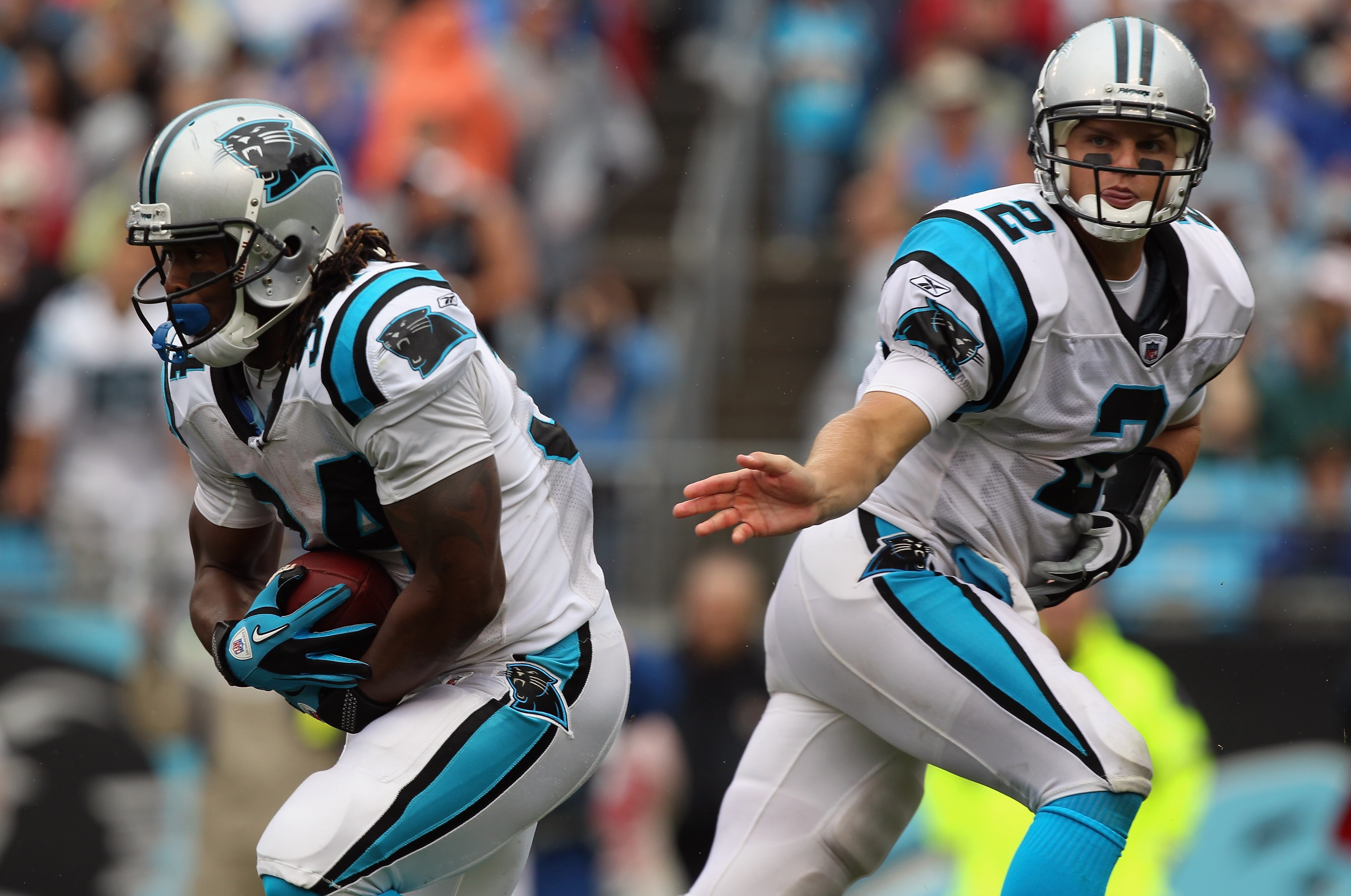 CHARLOTTE, NC - SEPTEMBER 26:  DeAngelo Williams #34 and teammate Casey Clausen #2 of the Carolina Panthers against the Cincinnati Bengals during their game at Bank of America Stadium on September 26, 2010 in Charlotte, North Carolina.  (Photo by Streeter