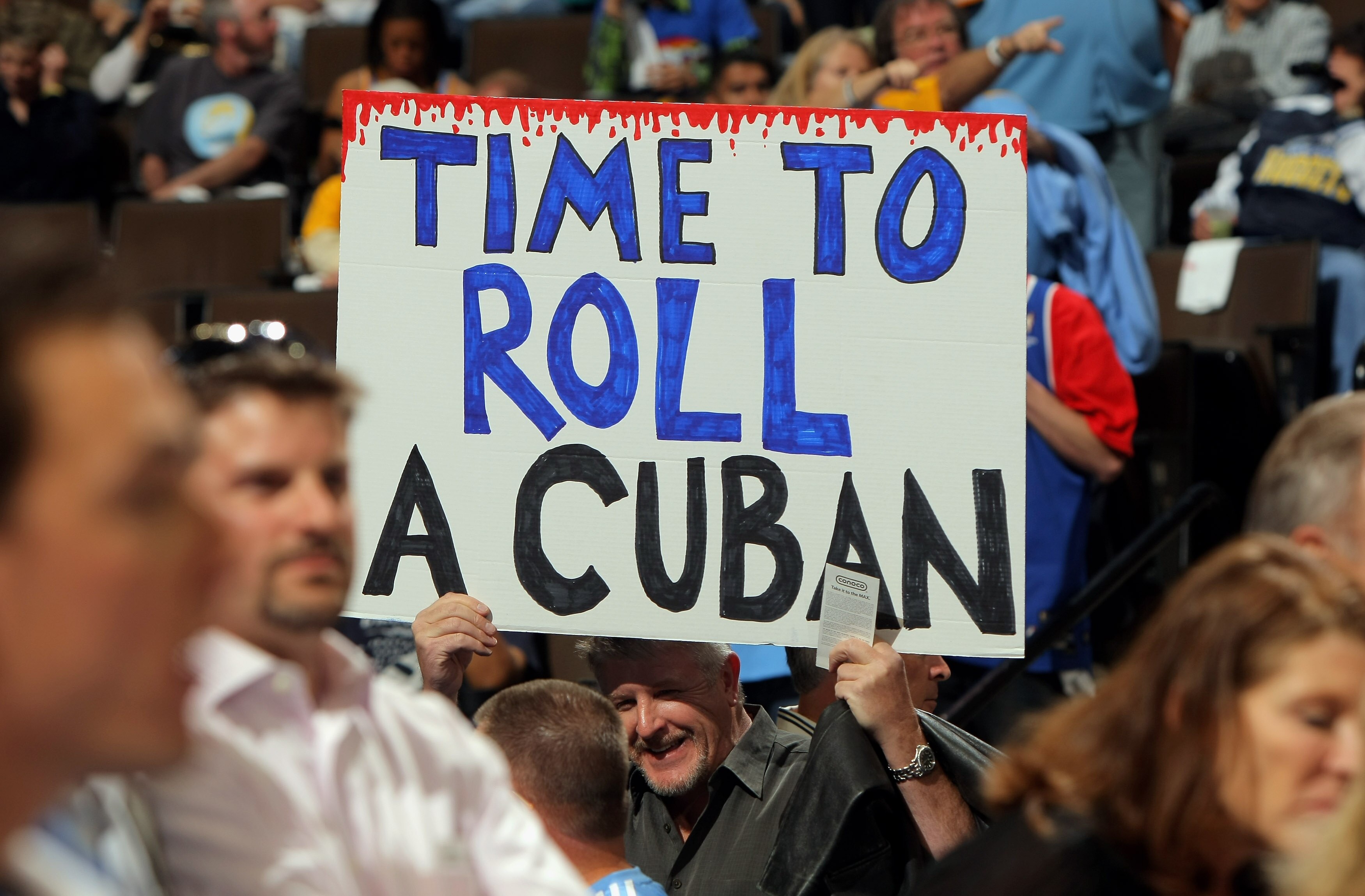 DENVER - MAY 13: A fan of the Denver Nuggets displays a sign referring to Dallas Mavericks owner Mark Cuban in Game Five of the Western Conference Semifinals during the 2009 NBA Playoffs at Pepsi Center on May 13, 2009 in Denver, Colorado. NOTE TO USER: DENVER - MAY 13: A fan of the Denver Nuggets displays a sign referring to Dallas Mavericks owner Mark Cuban in Game Five of the Western Conference Semifinals during the 2009 NBA Playoffs at Pepsi Center on May 13, 2009 in Denver, Colorado. NOTE TO USER: