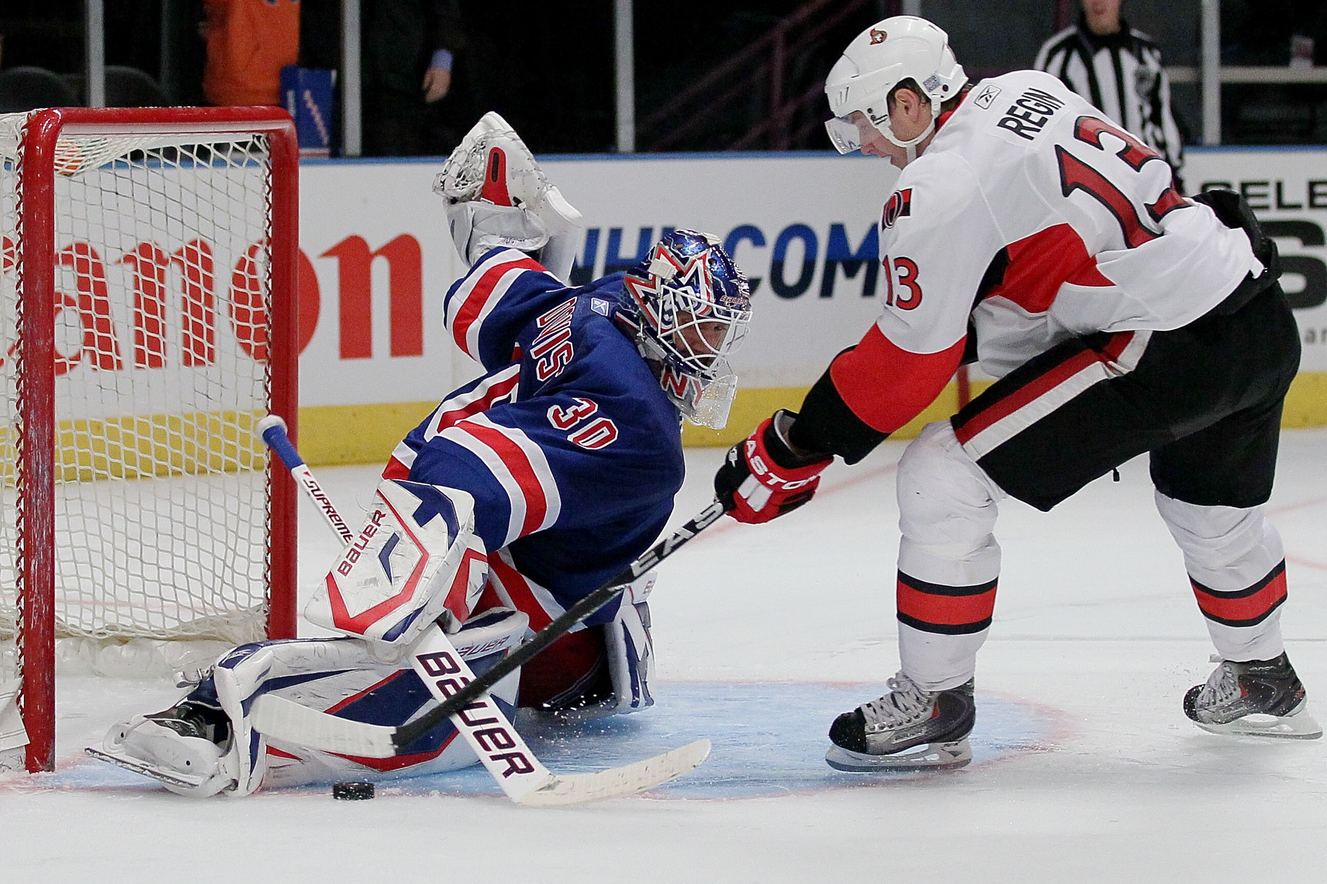 NEW YORK - OCTOBER 01: Goalkeeper Henrik Lundqvist #30 of the New York Rangers makes the winning save on a shot from Peter Regin #13 of the Ottawa Senators during their preseason game on October 1, 2010 at Madison Square Garden in New York City.  (Photo b
