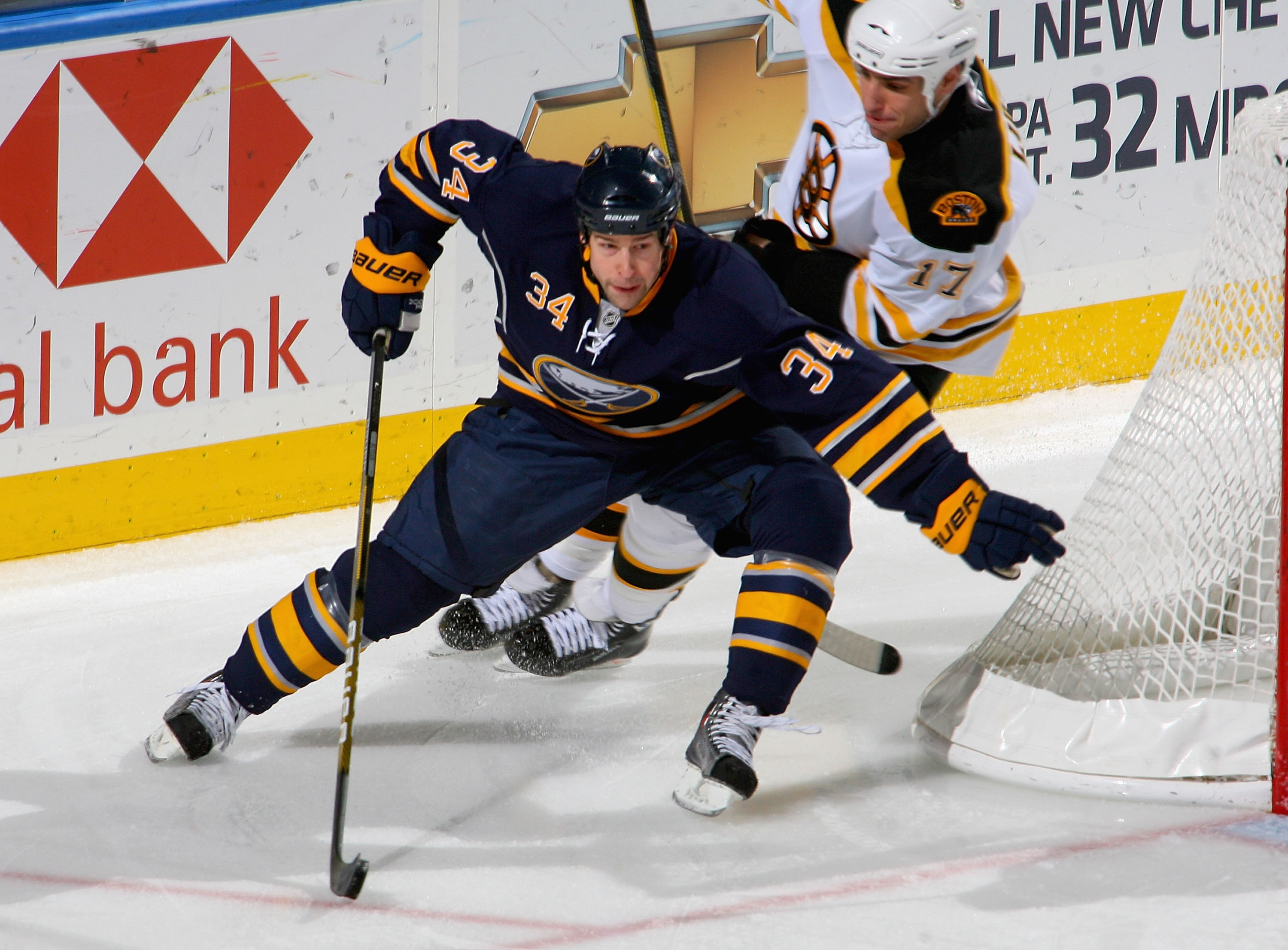 BUFFALO, NY - JANUARY 29: Chris Butler #34  of the Buffalo Sabres skates ahead of Milan Lucic #17 of the Boston Bruins at HSBC Arena on January 29, 2010 in Buffalo, New York.  (Photo by Rick Stewart/Getty Images)