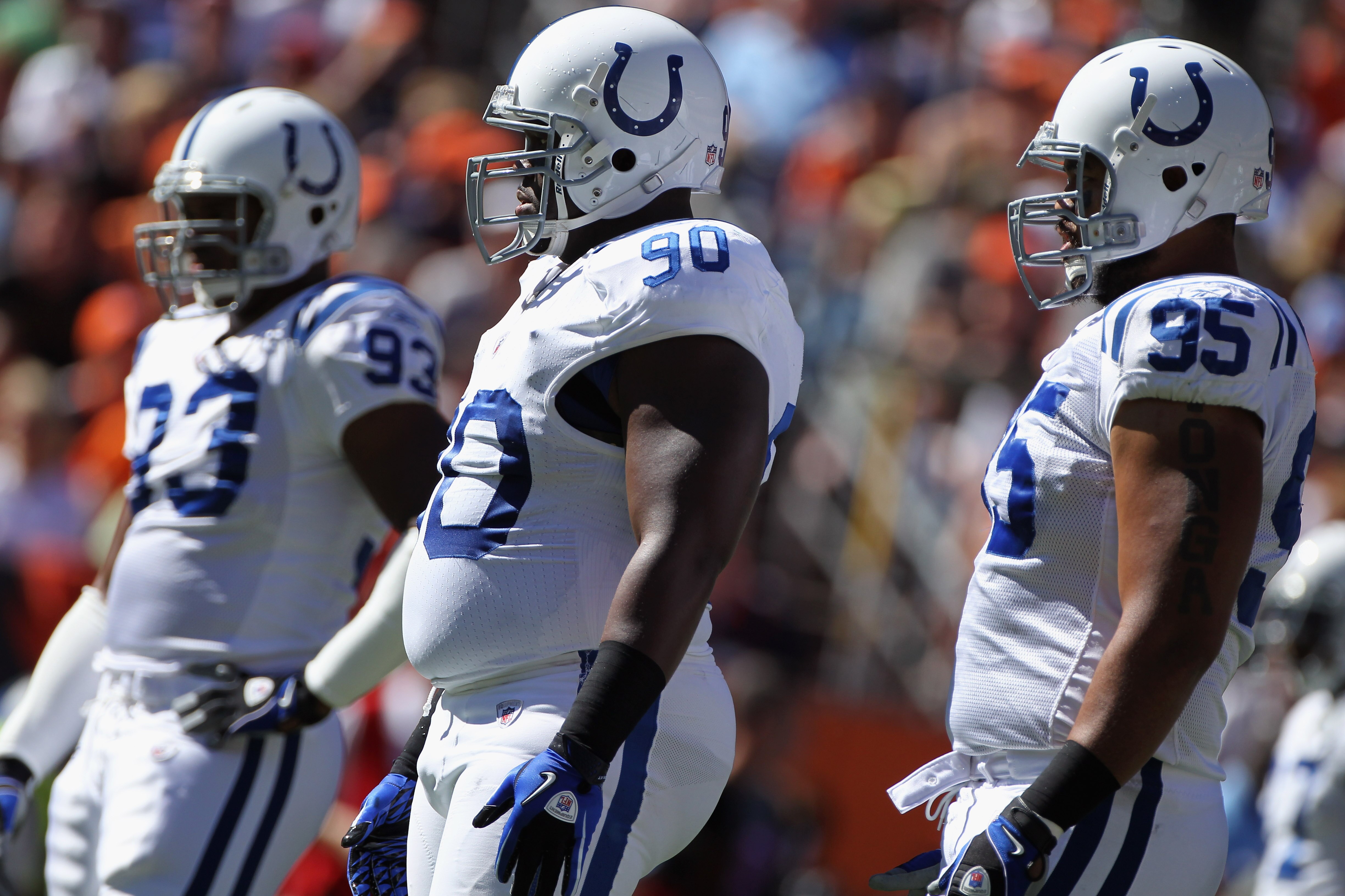 DENVER - SEPTEMBER 26:  Defensive linemen Dwight Freeney #93, Dan Muir #90 and Fili Moala #95 of the Indianapolis Colts prepare to play defense against the Denver Broncos at INVESCO Field at Mile High on September 26, 2010 in Denver, Colorado. The Colts d