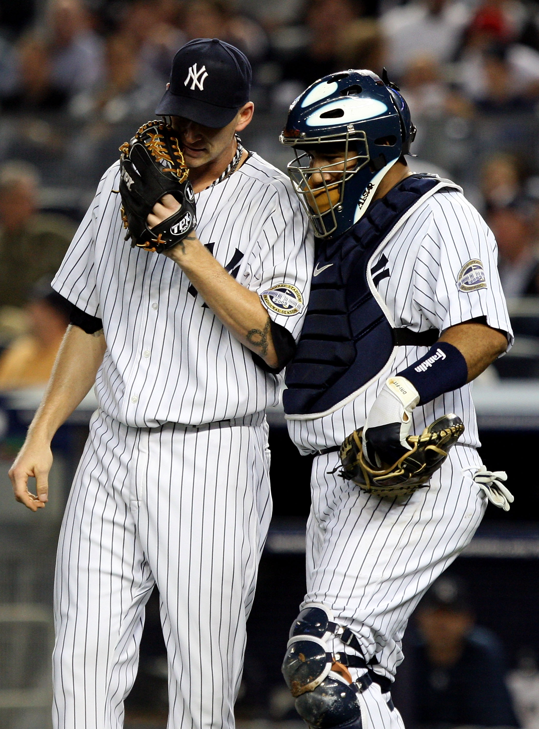 NEW YORK - OCTOBER 09:  Jose Molina #26 of the New York Yankees talks with starting pitcher A.J. Burnett #34 against the Minnesota Twins in Game Two of the ALDS during the 2009 MLB Playoffs at Yankee Stadium on October 9, 2009 in the Bronx borough of New