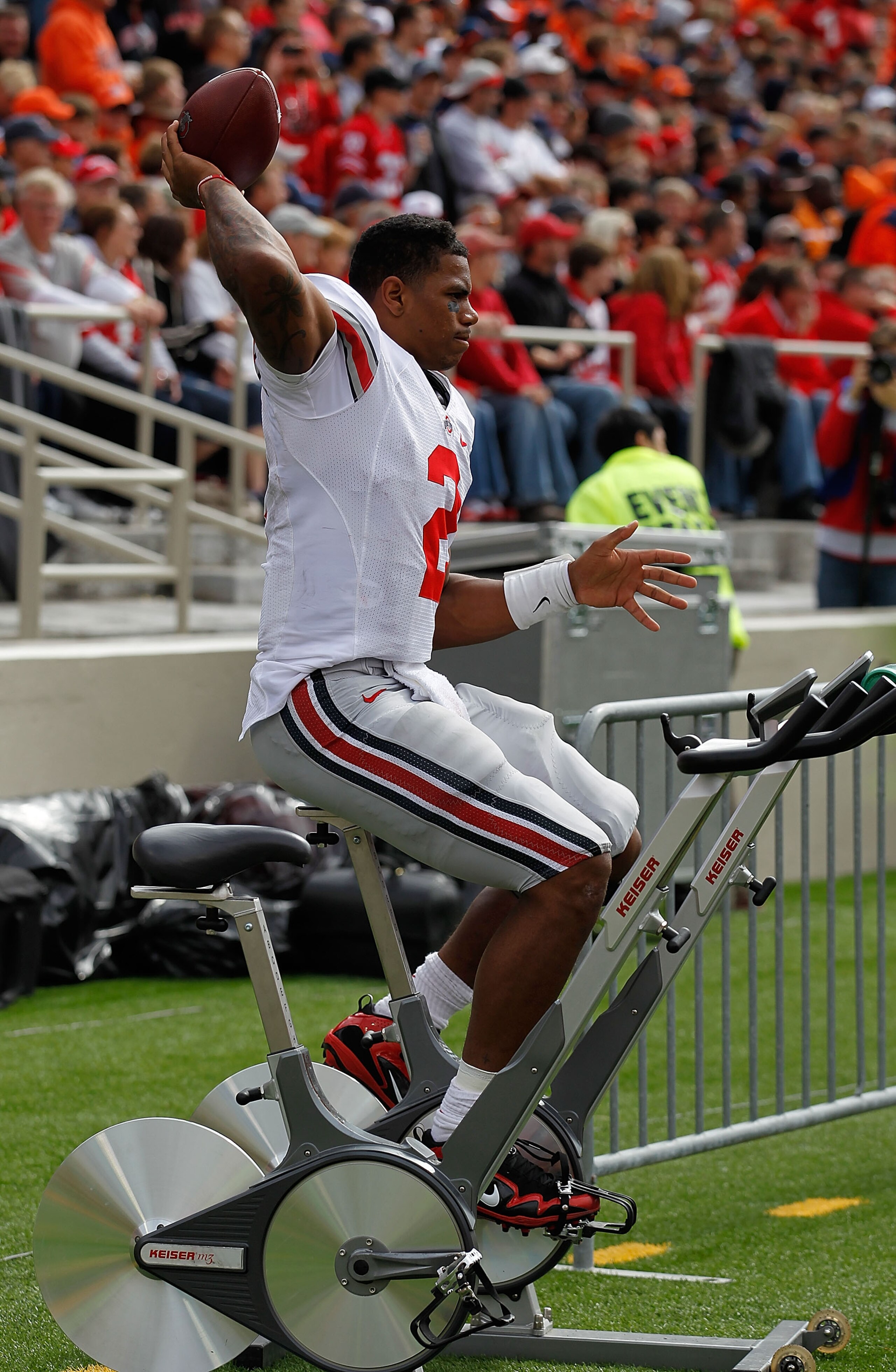 CHAMPAIGN, IL - OCTOBER 02: Terrelle Pryor #2 of the Ohio State Buckeyes throws a football while riding an exercise bicycle on the sidelines after suffering a leg injury against the Illinois Fighting Illini at Memorial Stadium on October 2, 2010 in Champa
