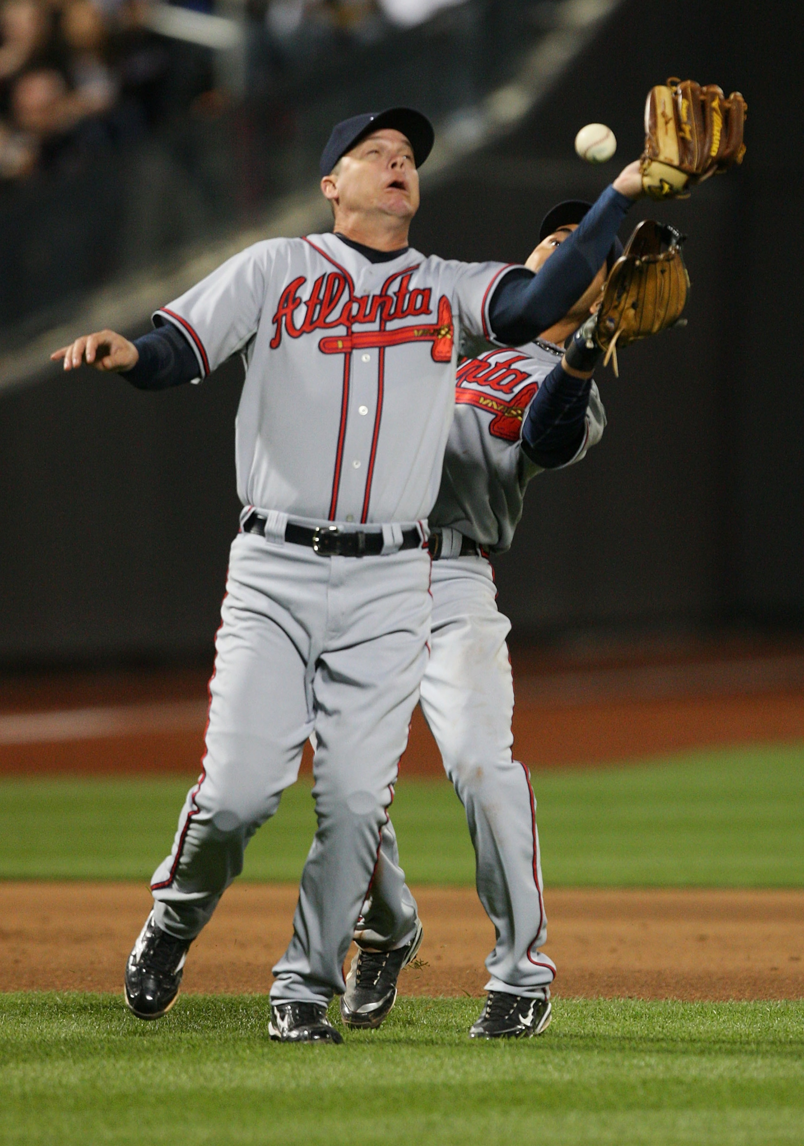NEW YORK - APRIL 23: Chipper Jones #10 and Omar Infante #4 of the Atlanta Braves collide and drop a fly ball against the New York Mets on April 23, 2010 at Citi Field in the Flushing neighborhood of the Queens borough of New York City.  (Photo by Mike Sto