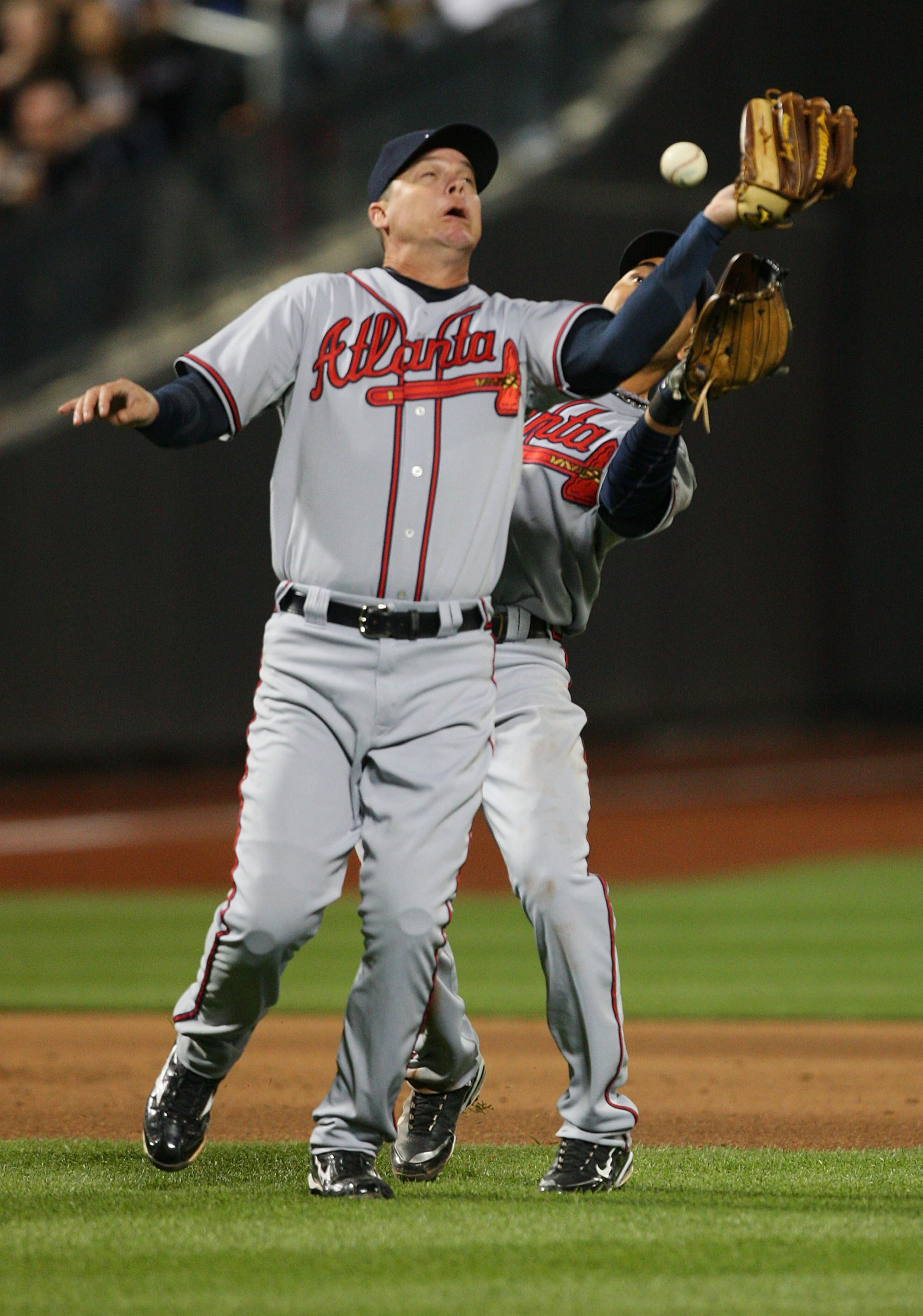 NEW YORK - APRIL 23: Chipper Jones #10 and Omar Infante #4 of the Atlanta Braves collide and drop a fly ball against the New York Mets on April 23, 2010 at Citi Field in the Flushing neighborhood of the Queens borough of New York City.  (Photo by Mike Sto