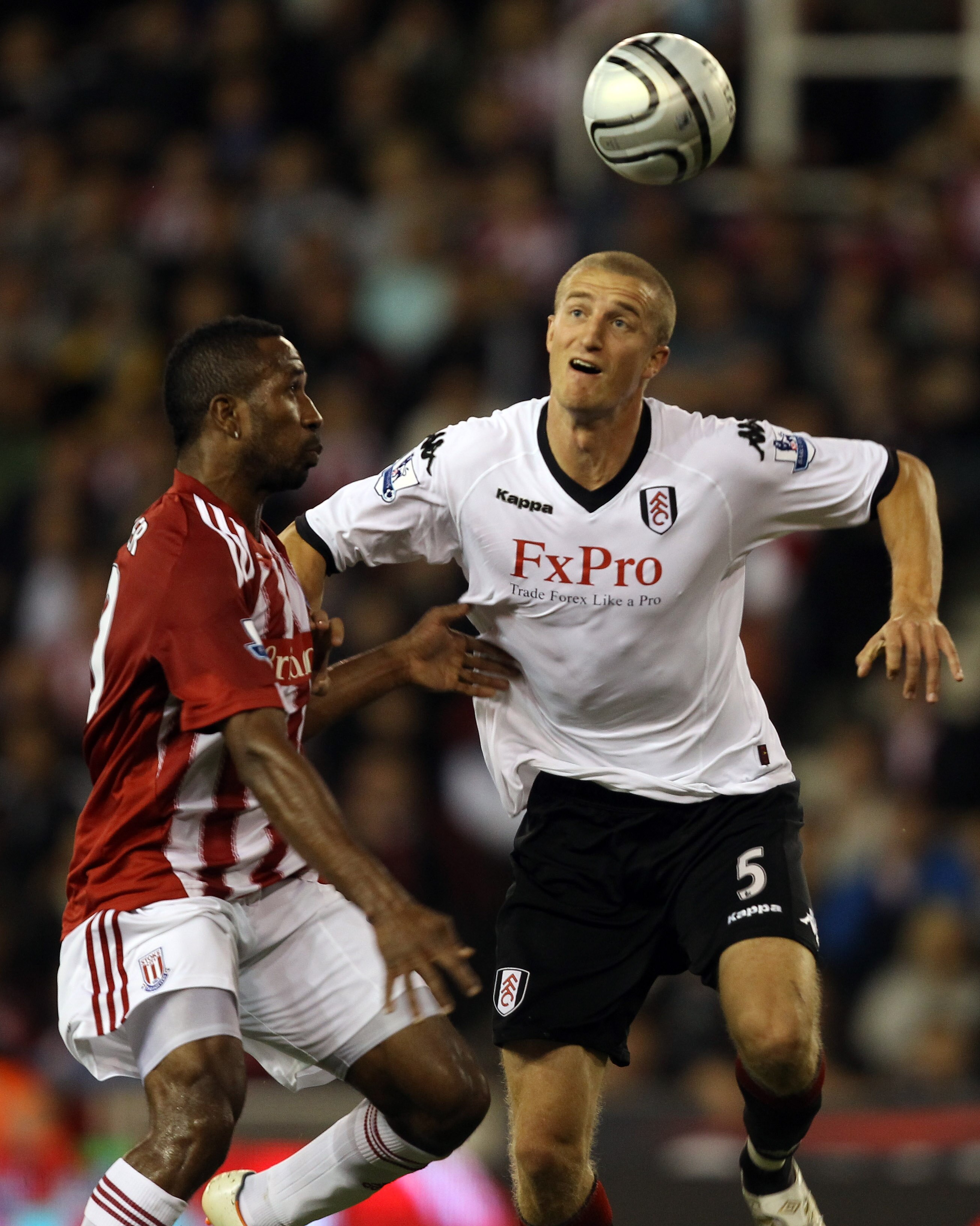 STOKE ON TRENT, ENGLAND - SEPTEMBER 21:  Ricardo Fuller of Stoke is challenged by Brede Hangeland of Fulham during the Carling Cup 3rd Round tie between Stoke City and Fulham at the Britannia Stadium on September 21, 2010 in Stoke on Trent, England.  (Pho