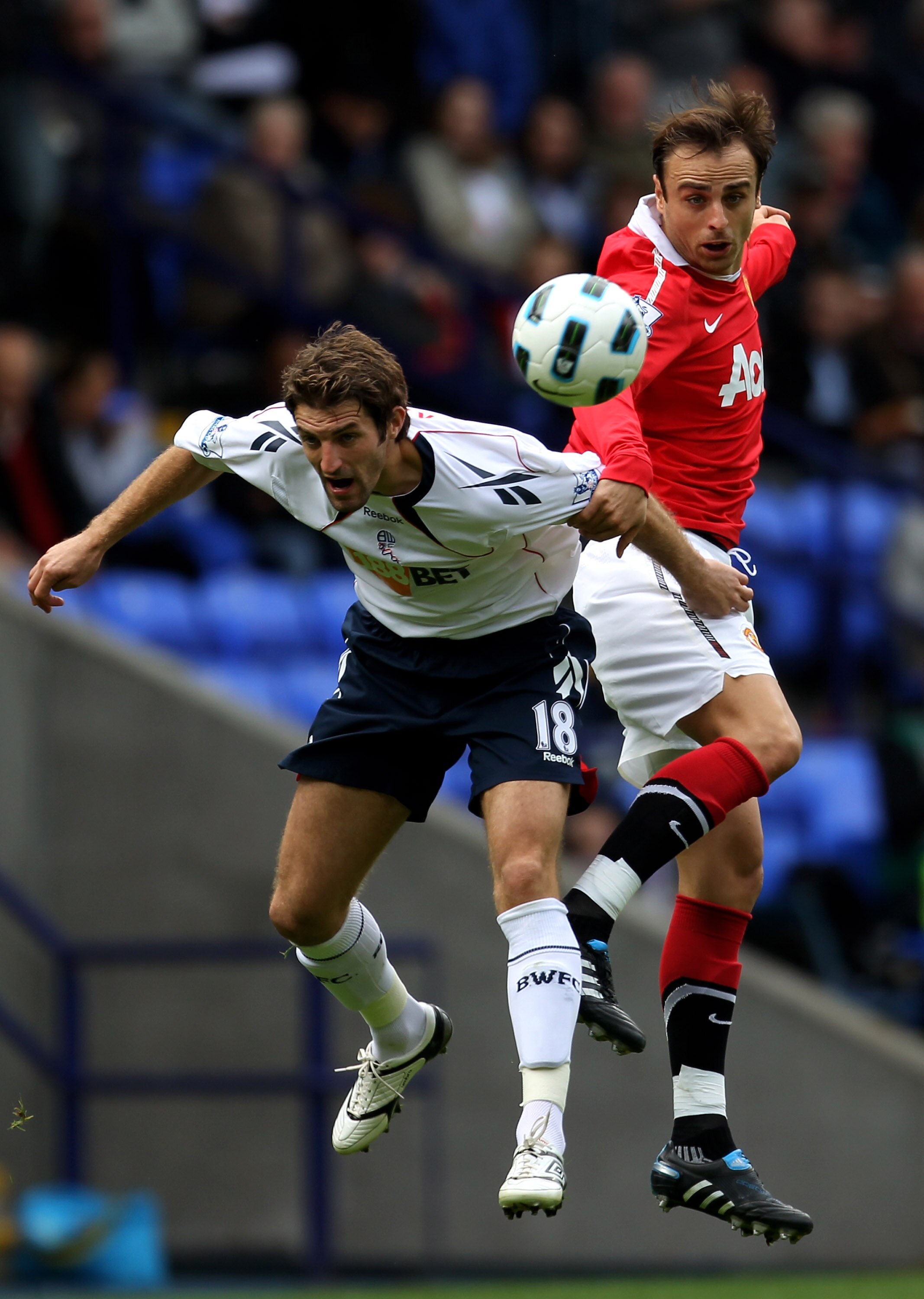 BOLTON, ENGLAND - SEPTEMBER 26:  Sam Ricketts of Bolton Wanderers competes with Dimitar Berbatov of Manchester United during the Barclays Premier League match between Bolton Wanderers and Manchester United at the Reebok Stadium on September 26, 2010 in Bo