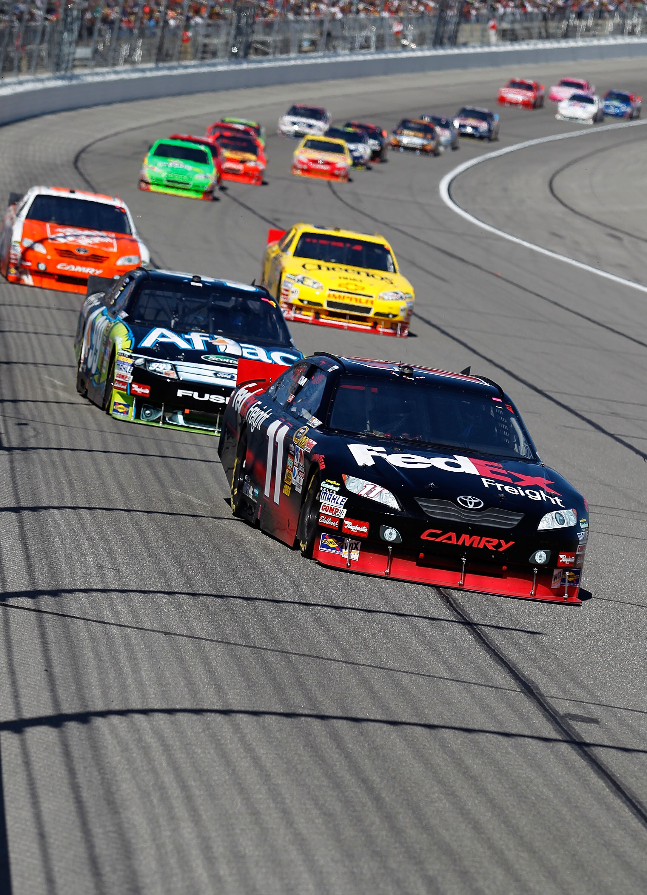 KANSAS CITY, KS - OCTOBER 03:  Denny Hamlin, driver of the #11 FedEx Freight Toyota, leads a pack of cars during the NASCAR Sprint Cup Series Price Chopper 400 on October 3, 2010 in Kansas City, Kansas.  (Photo by Todd Warshaw/Getty Images)