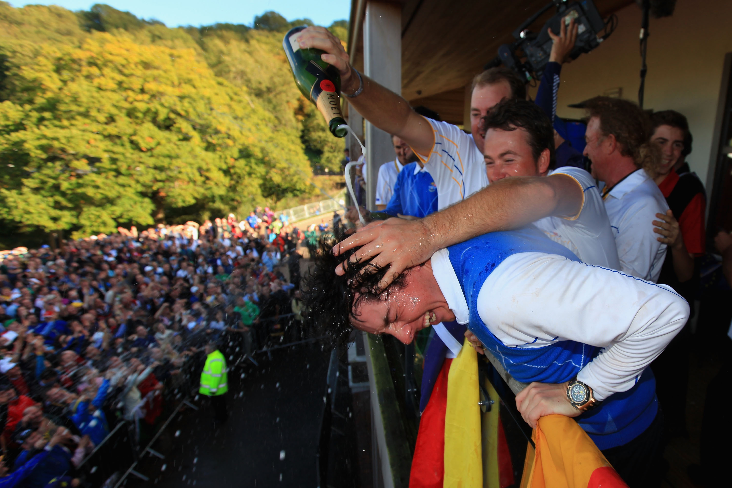 NEWPORT, WALES - OCTOBER 04:  Rory McIlroy of Europe is drenched with champagne on the balcony of the clubhouse following Europe's victory in the 2010 Ryder Cup at the Celtic Manor Resort on October 4, 2010 in Newport, Wales.  (Photo by David Cannon/Getty