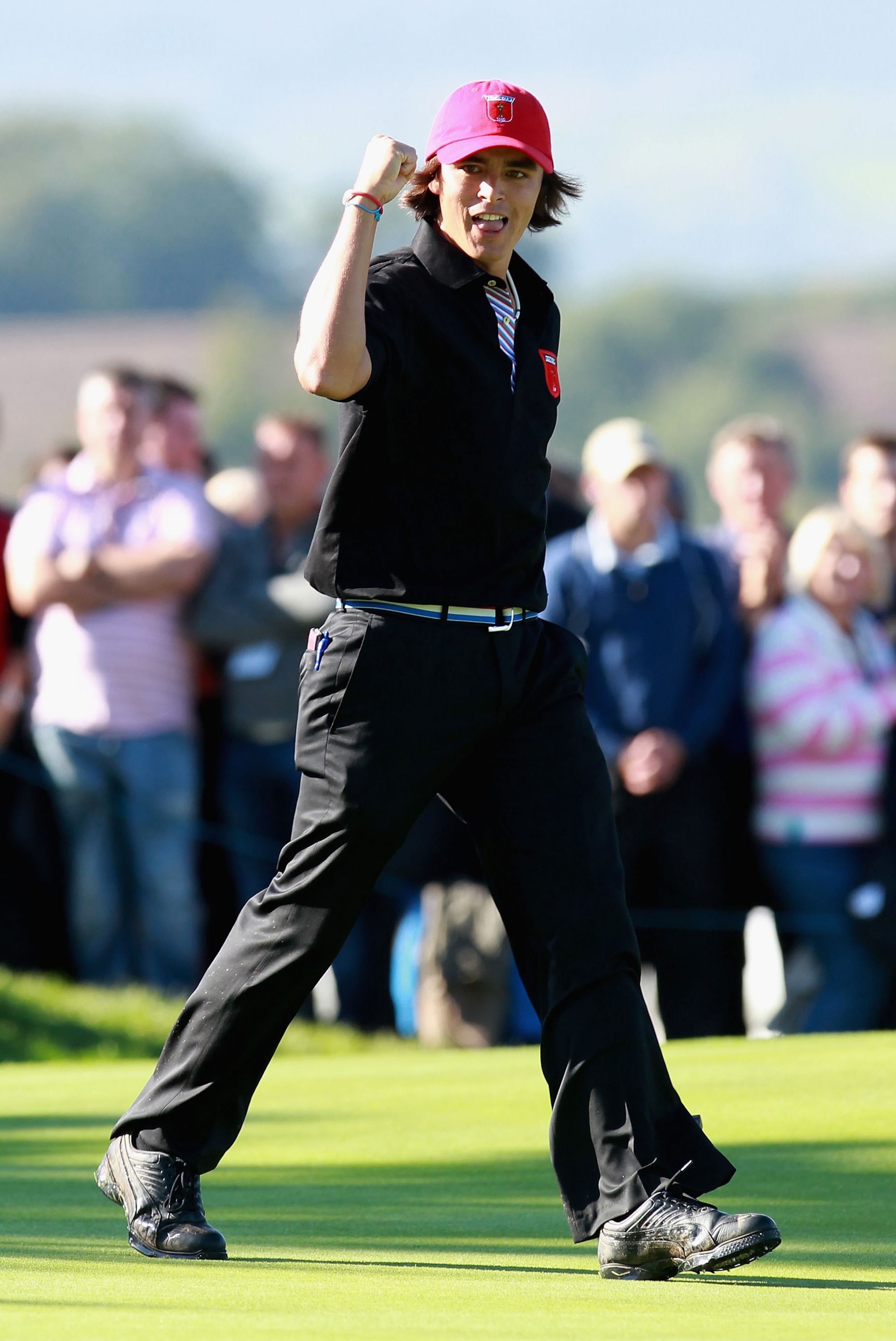 NEWPORT, WALES - OCTOBER 04:  Rickie Fowler of the USA celebrates on the 18th green after halving in the singles matches during the 2010 Ryder Cup at the Celtic Manor Resort on October 4, 2010 in Newport, Wales.  (Photo by Andrew Redington/Getty Images)