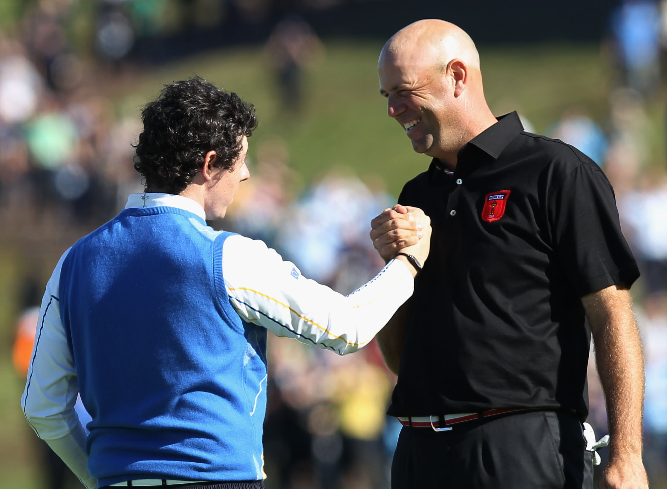 NEWPORT, WALES - OCTOBER 04:  Rory McIlroy of Europe shakes hands with Stewart Cink (R) of the USA on the 18th green after they halved their match in the singles matches during the 2010 Ryder Cup at the Celtic Manor Resort on October 4, 2010 in Newport, W