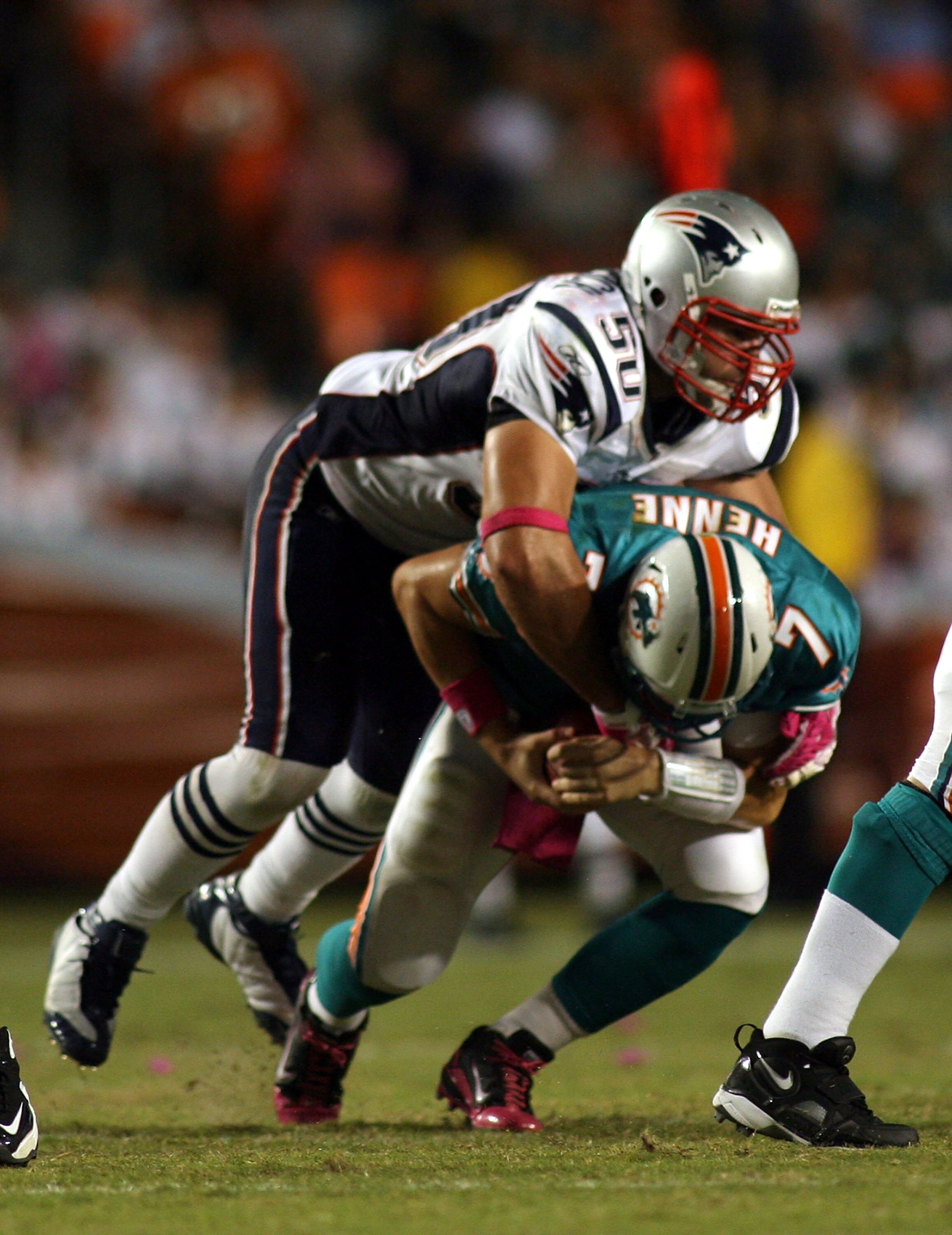MIAMI - OCTOBER 04:  Quarterback Chad Henne #7 of the Miami Dolphinsis sacked by linebacker Rob Ninkovich #50 of the New England Patriots at Sun Life Stadium on October 4, 2010 in Miami, Florida.  (Photo by Marc Serota/Getty Images)