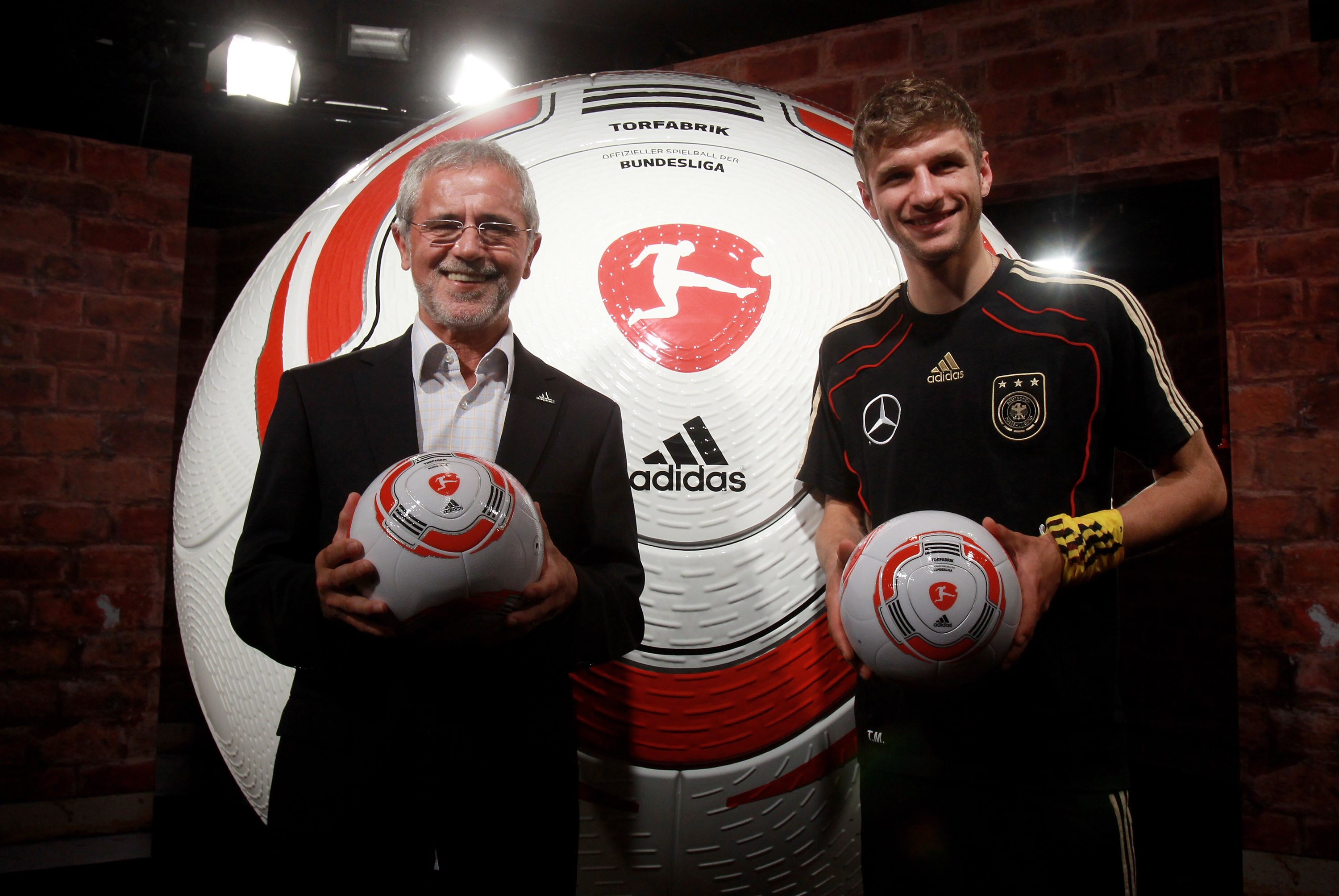 PRETORIA, SOUTH AFRICA - JUNE 15:  Thomas Mueller (R) of Germany and former german football player Gerd Mueller are pictured with the first official ball, 'Torfabrik' for the german bundesliga during a press conference of adidas and the DFL in the media c