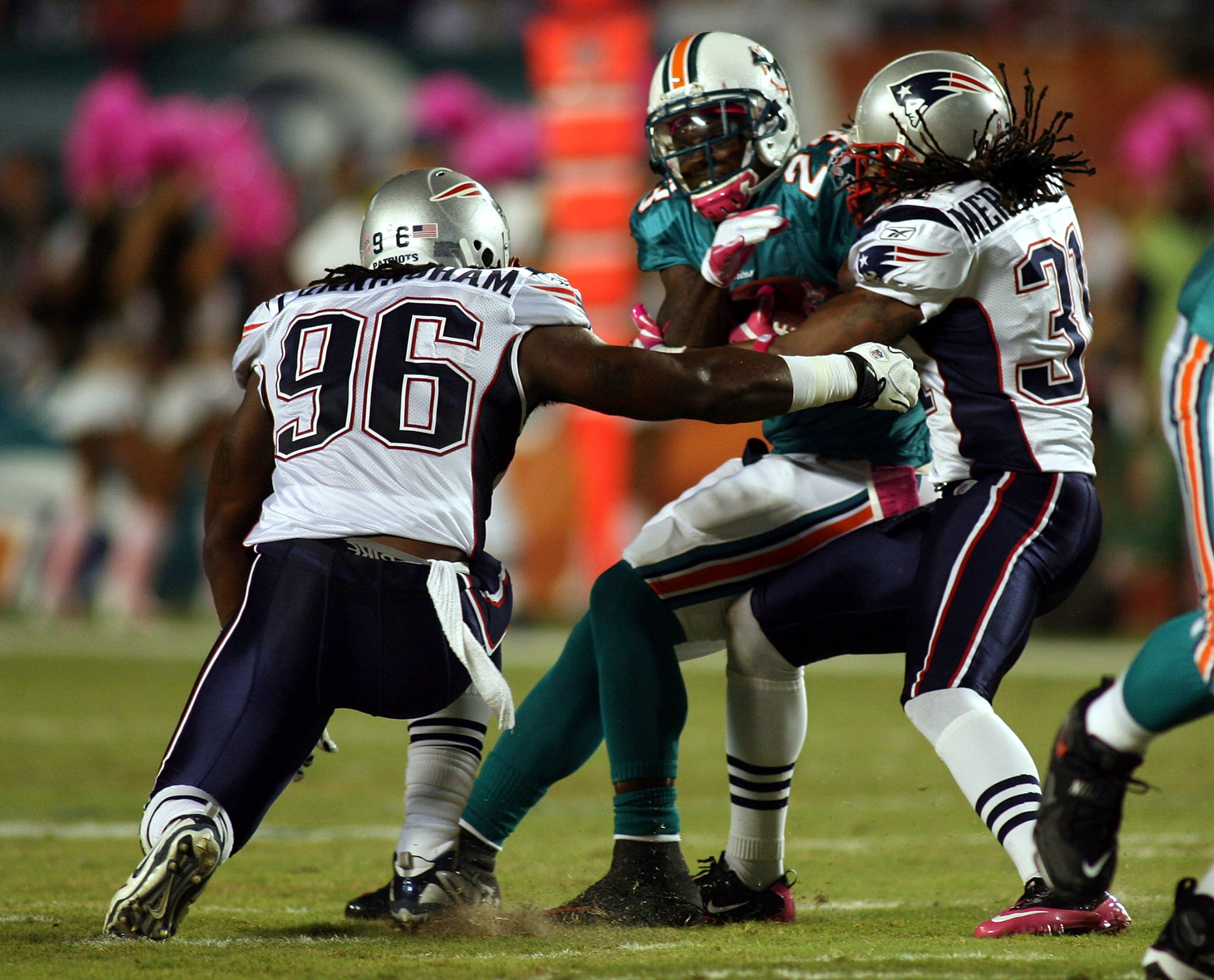 MIAMI - OCTOBER 04:  Running back Ronnie Brown #23 of the Miami Dolphinsis brought down by safety Brandon Meriweather #31 of the New England Patriots at Sun Life Stadium on October 4, 2010 in Miami, Florida.  (Photo by Marc Serota/Getty Images)
