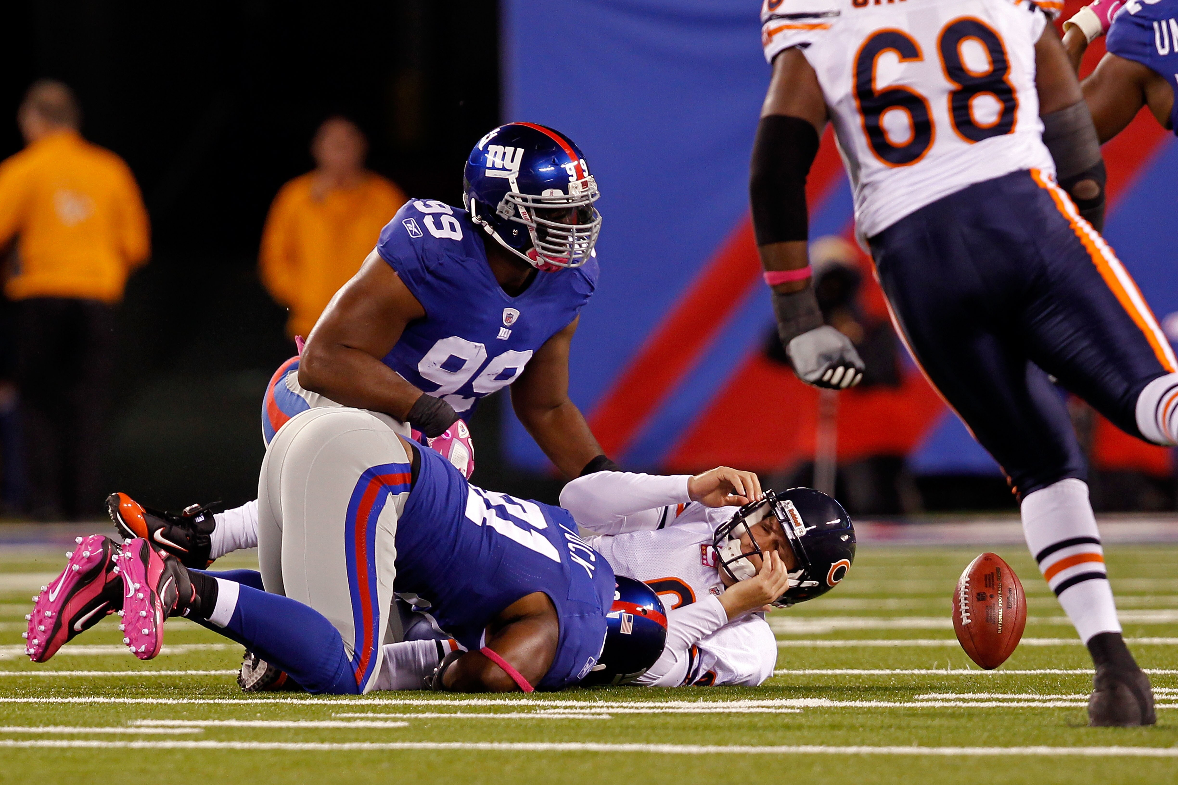 EAST RUTHERFORD, NJ - OCTOBER 03:  Jay Cutler #6 of the Chicago Bears gets sacked by Justin Tuck #91 and Chris Canty #99 of the New York Giants at New Meadowlands Stadium on October 3, 2010 in East Rutherford, New Jersey.  (Photo by Michael Heiman/Getty I
