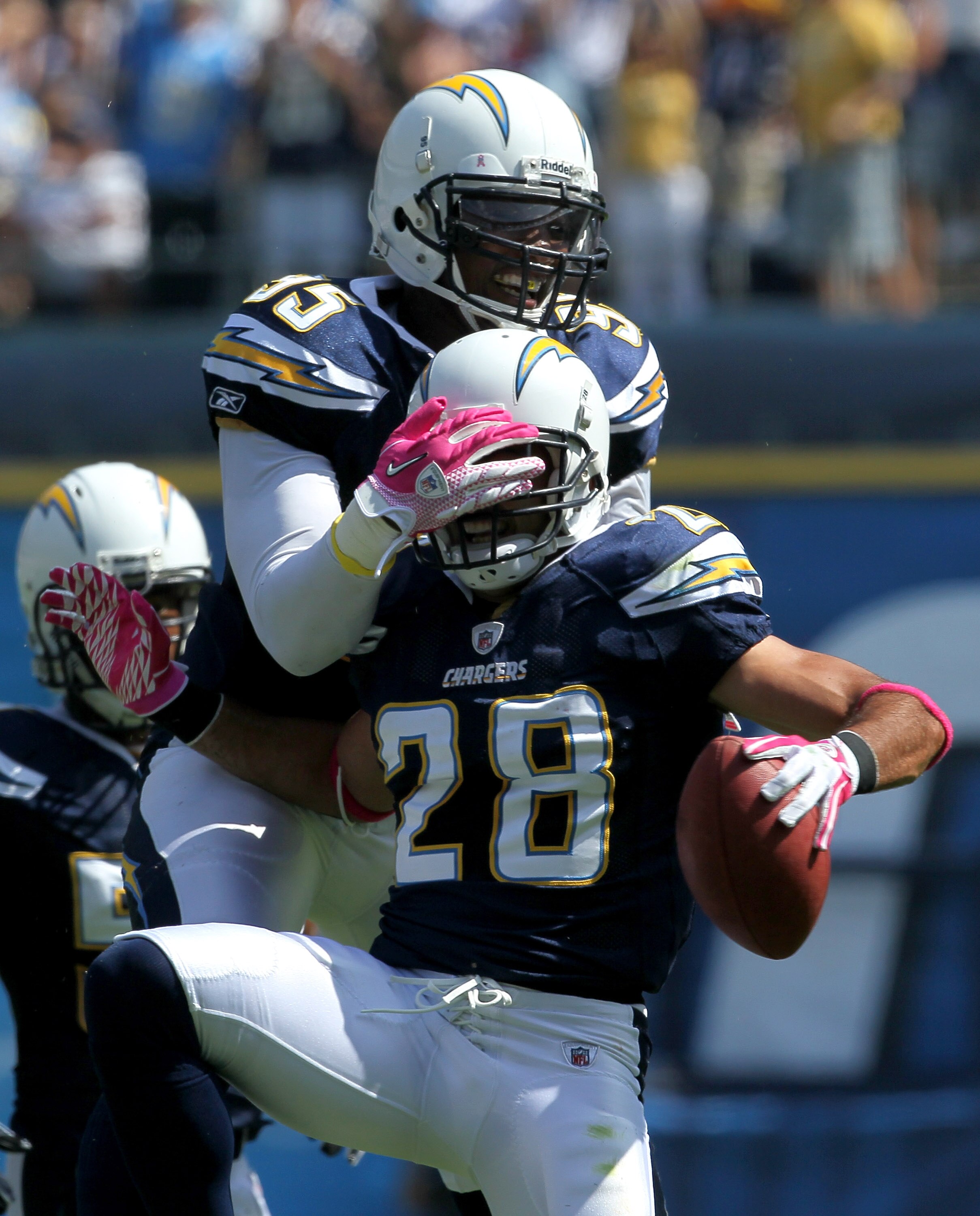 SAN DIEGO - OCTOBER 3:  Safety Stephen Gregory #28 of the San Diego Chargers celebrates his interception with linebacker Shaun Phillips #95 in the game with the Arizona Cardinals at Qualcomm Stadium on October 3, 2010 in San Diego, California.   The Charg