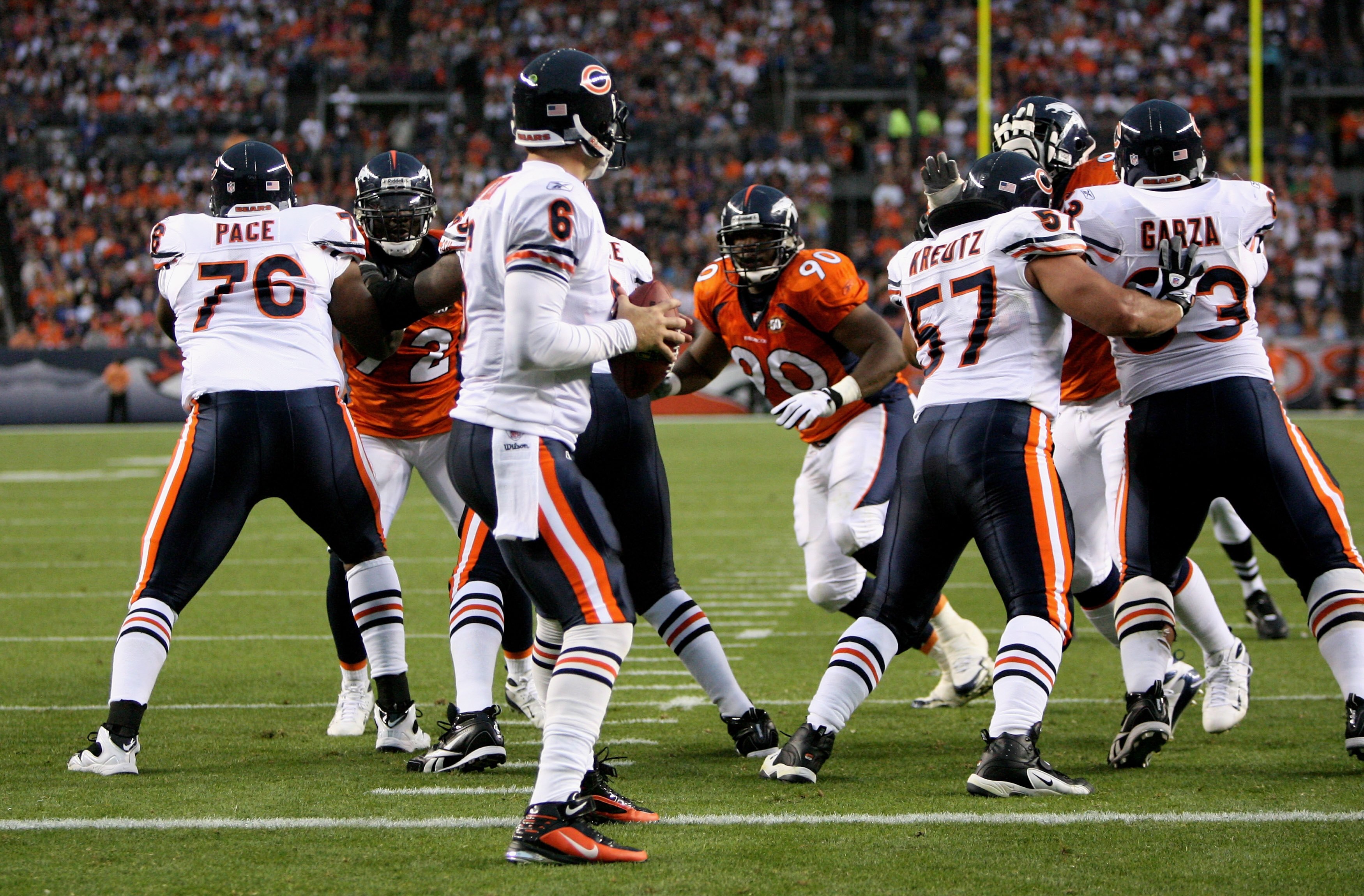 DENVER - AUGUST 30:  Quarterback Jay Cutler #6 of the Chicago Bears is protected by his offensive linemen Orlando Pace #76, Olin Kreutz #57 and Roberto Garza #57 against the Denver Broncos during preseason NFL action at INVESCO Field at Mile High on Augus