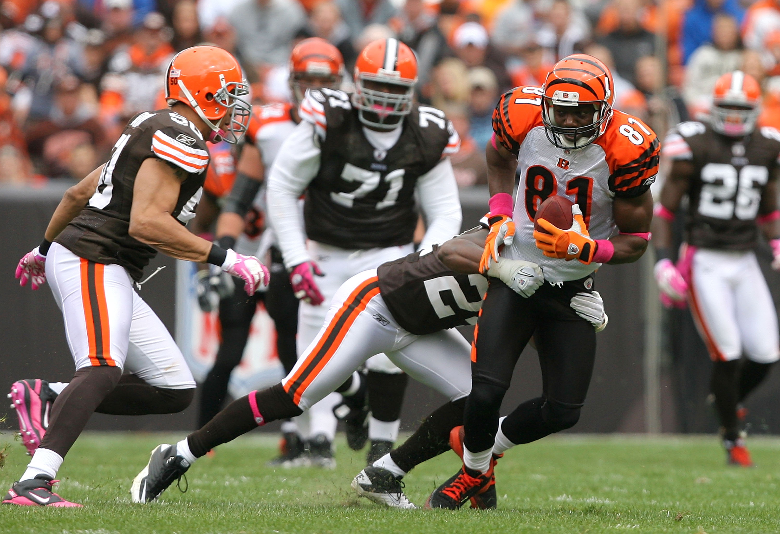 CLEVELAND - OCTOBER 03:  Wide receiver Terrell Owens #81 of the Cincinnati Bengals is hit by defenders Sheldon Brown #24 and Eric Barton #50 (L) of the Cleveland Browns at Cleveland Browns Stadium on October 3, 2010 in Cleveland, Ohio.  (Photo by Matt Sul
