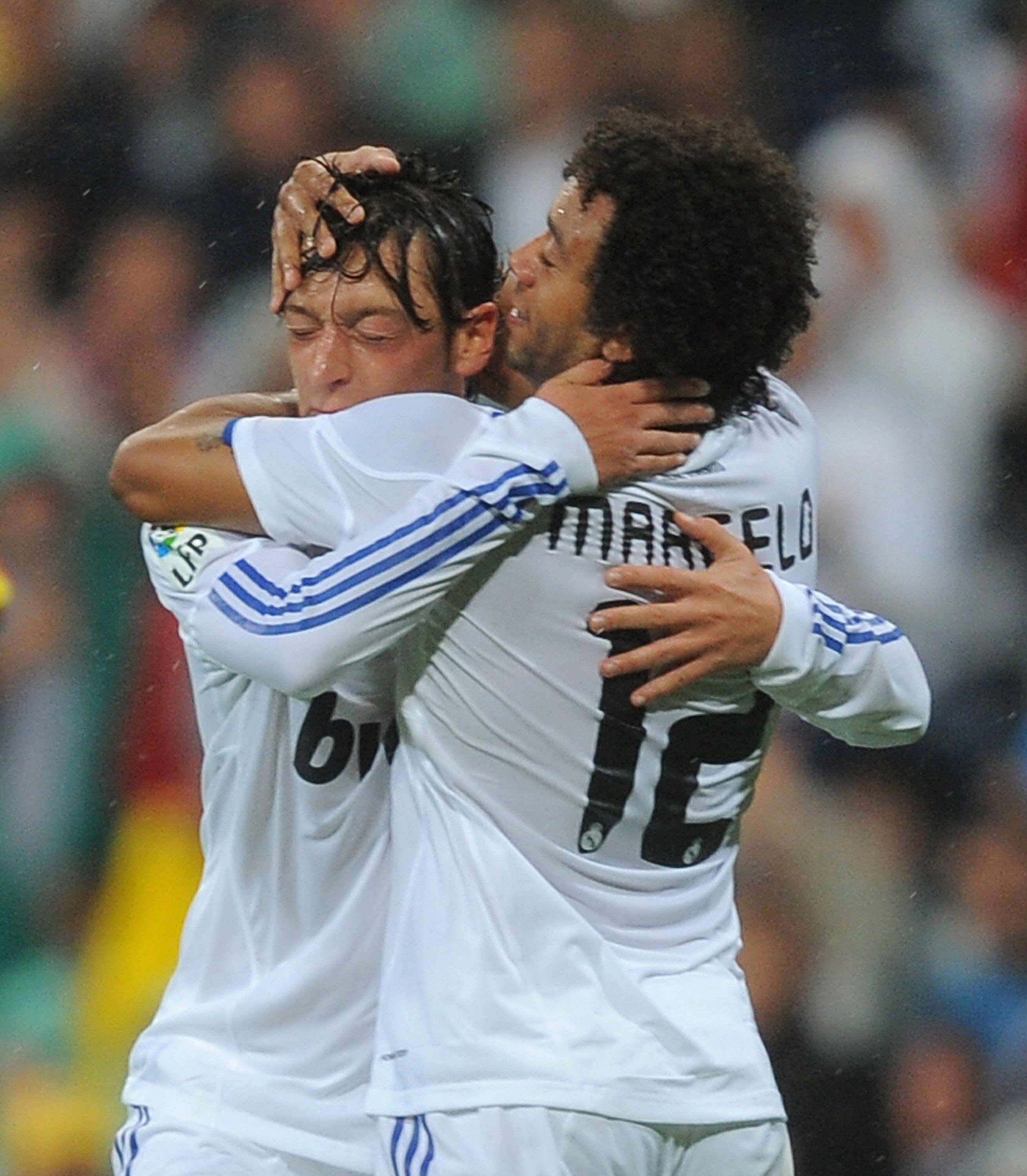 MADRID, SPAIN - OCTOBER 03:  Mesut Ozil (L) of Real Madrid celebrates with Marcelo after scoring Real's first goal during the La Liga match between Real Madrid and Deportivo La Coruna at Estadio Santiago Bernabeu on October 3, 2010 in Madrid, Spain.  (Pho