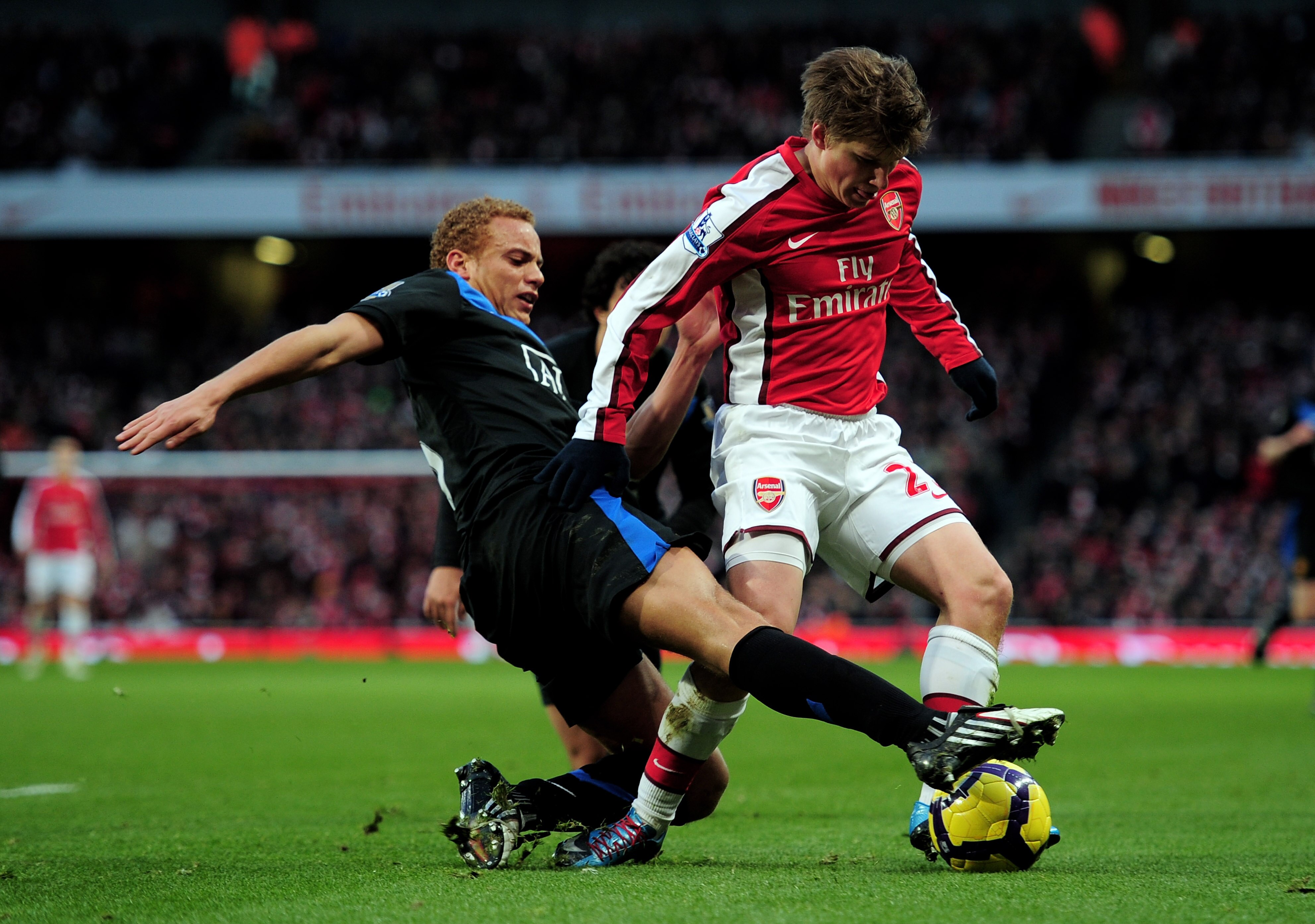 LONDON, ENGLAND - JANUARY 31: Andrei Arshavin of Arsenal is tackled by Wes Brown of Manchester United during the Barclays Premier League match between Arsenal and Manchester United at The Emirates Stadium on January 31, 2010 in London, England. (Photo b LONDON, ENGLAND - JANUARY 31: Andrei Arshavin of Arsenal is tackled by Wes Brown of Manchester United during the Barclays Premier League match between Arsenal and Manchester United at The Emirates Stadium on January 31, 2010 in London, England. (Photo b