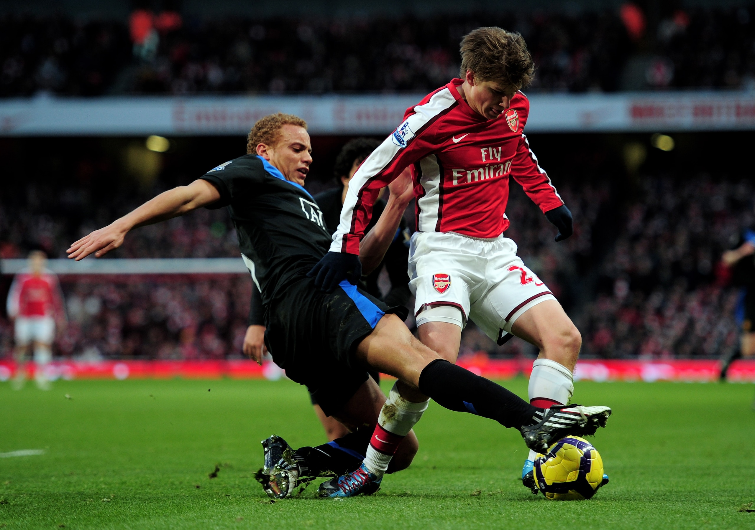 LONDON, ENGLAND - JANUARY 31:  Andrei Arshavin of Arsenal is tackled by Wes Brown of Manchester United during the Barclays Premier League match between Arsenal and Manchester United at The Emirates Stadium on January 31, 2010 in London, England.  (Photo b