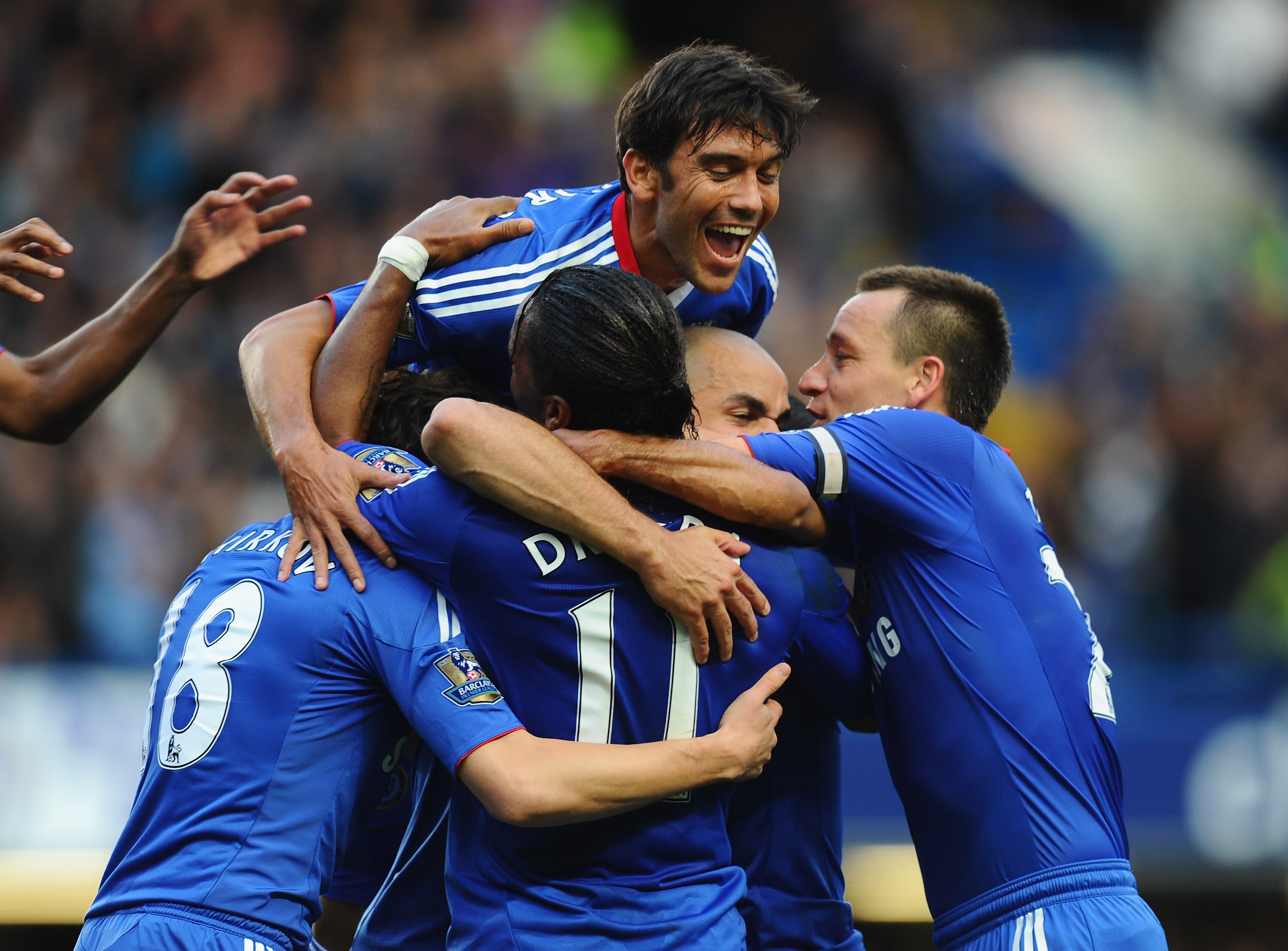 LONDON, ENGLAND - OCTOBER 03:  Alex of Chelsea is buried by team mates after scoring during the Barclays Premier League match between Chelsea and Arsenal at Stamford Bridge on October 3, 2010 in London, England.  (Photo by Mike Hewitt/Getty Images)