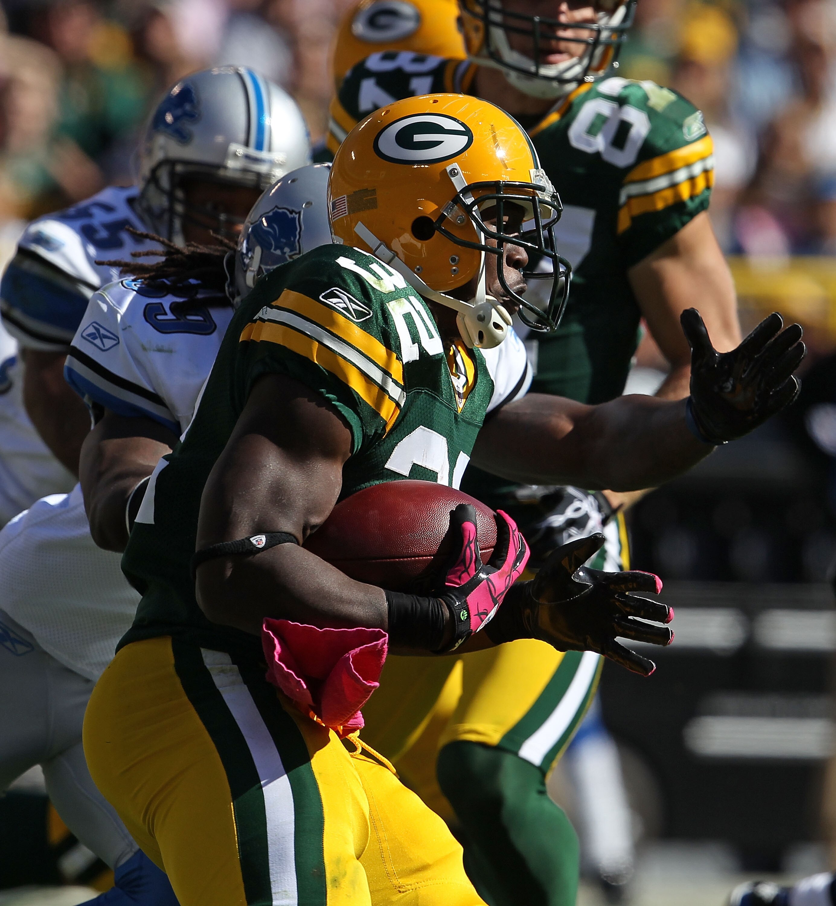 GREEN BAY, WI - OCTOBER 03: Brandon Jackson #32 of the Green Bay Packers rushes pursued by C.C. Brown #39 of the Detroit Lions at Lambeau Field on October 3, 2010 in Green Bay, Wisconsin. The Packers defeated the Lions 28-26. (Photo by Jonathan Daniel/Get