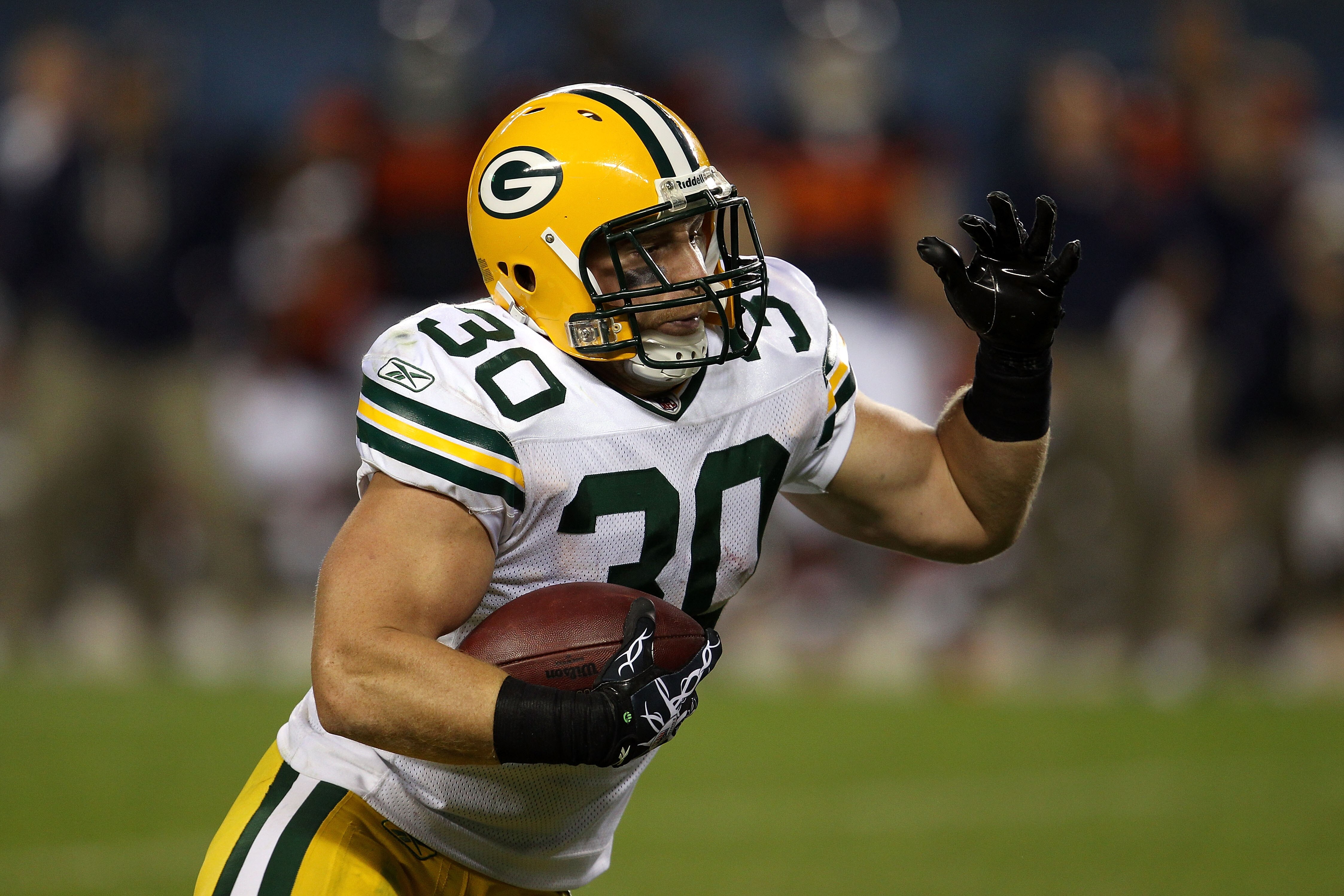 CHICAGO - SEPTEMBER 27:  John Kuhn #30 of the Green Bay Packers runs the ball against the Chicago Bears at Soldier Field on September 27, 2010 in Chicago, Illinois.  (Photo by Jonathan Daniel/Getty Images)
