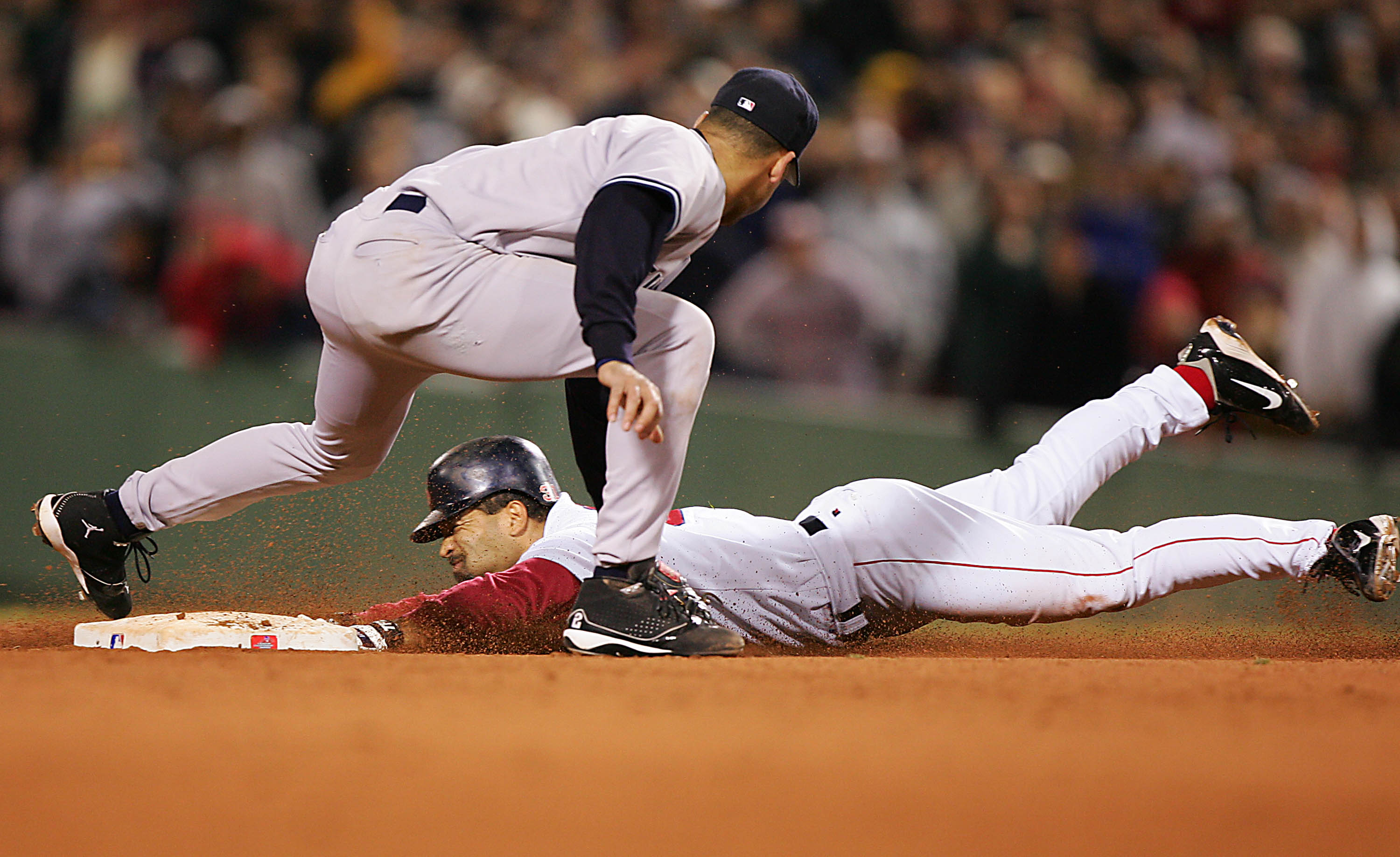 BOSTON - OCTOBER 17:  Dave Roberts #31 of the Boston Red Sox steals second base while shortstop Derek Jeter #2 of the New York Yankees applies the tag in the ninth inning during game four of the American League Championship Series on October 17, 2004 at F