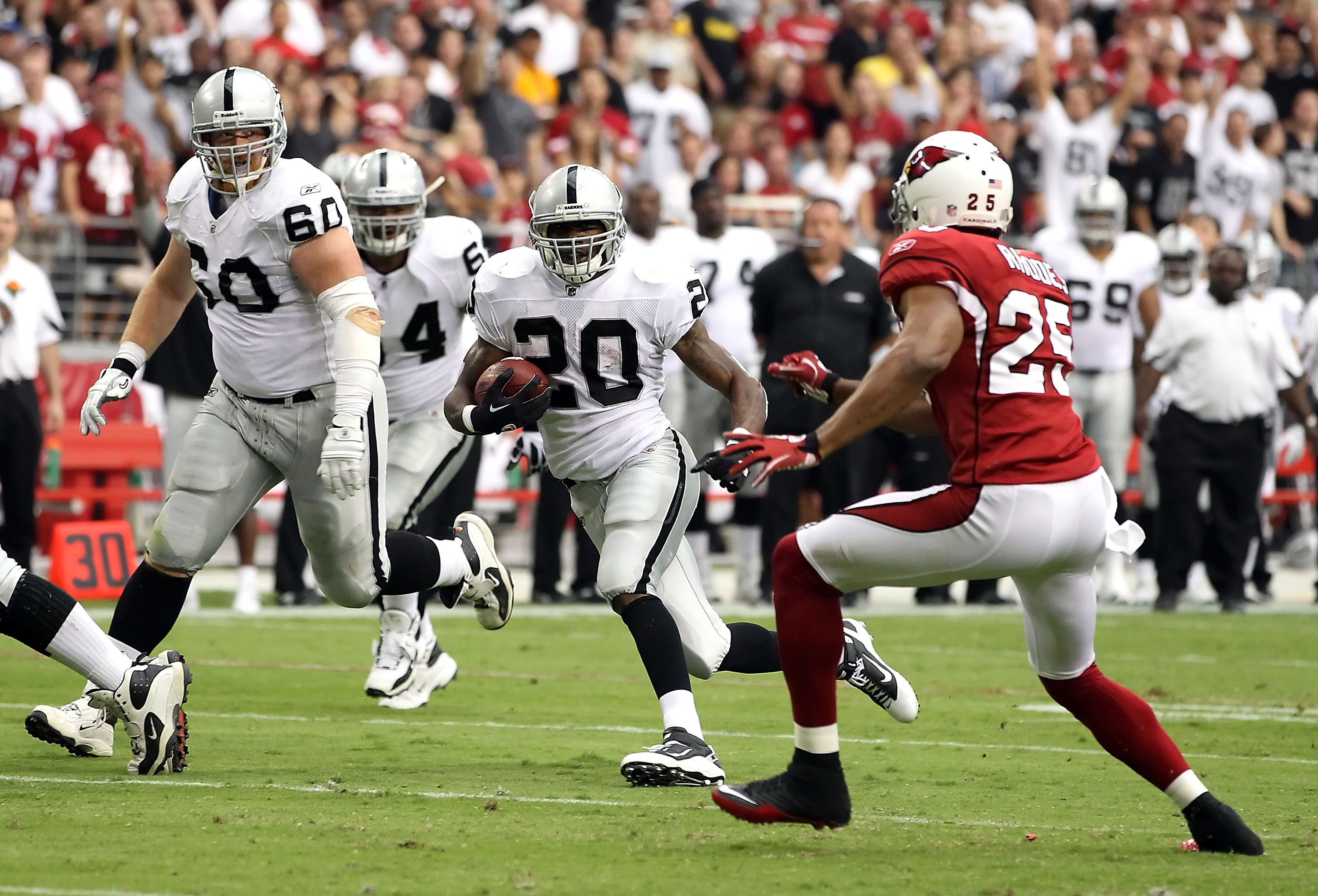GLENDALE, AZ - SEPTEMBER 26:  Runningback Darren McFadden #20 of the Oakland Raiders rushes the football during the NFL game against the Arizona Cardinals at the University of Phoenix Stadium on September 26, 2010 in Glendale, Arizona.  The Cardinals defe