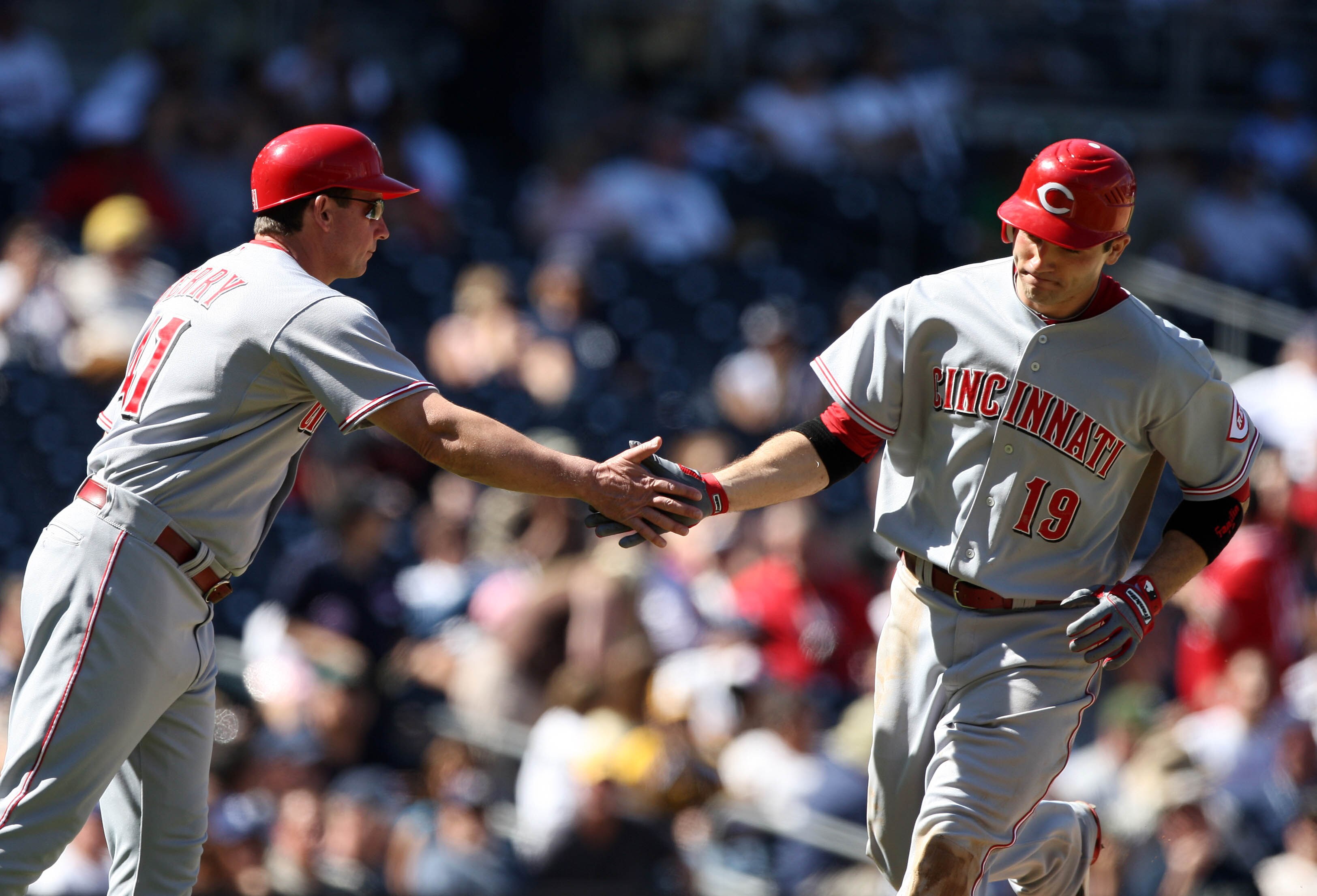 SAN DIEGO, CA - SEPTEMBER 25:  Joey Votto  #19 of Cincinnati Reds rounds third base after hitting a solo home run and is met by 3rd base coach Mark Berry against the San Diego Padres during their MLB game on September 25, 2010 at PETCO Park in San Diego, 
