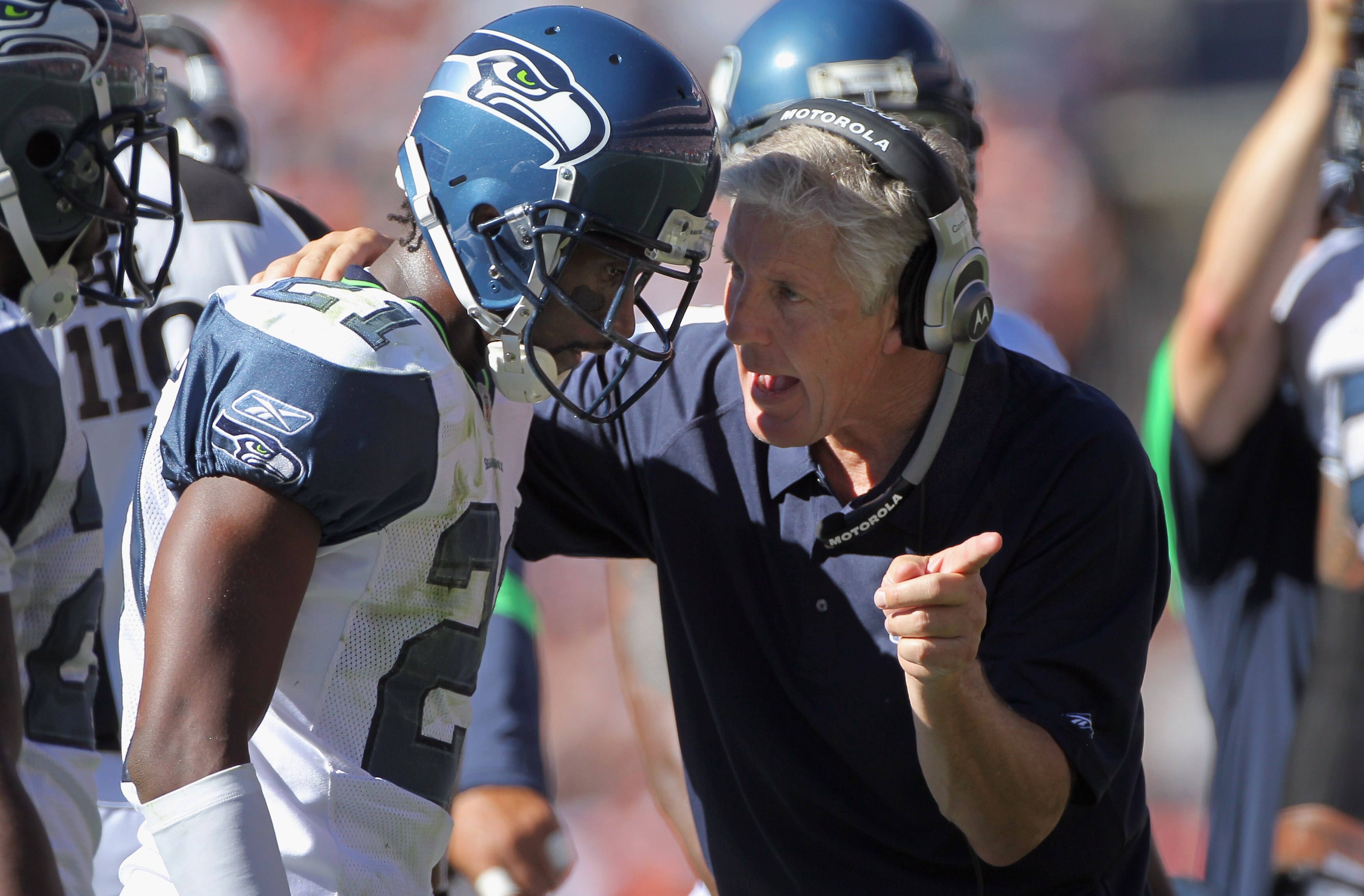 DENVER - SEPTEMBER 19:  Head coach Pete Carroll of the Seattle Seahawks directs cornerback Kelly Jennings #21 during a break in the action against the Denver Broncos at INVESCO Field at Mile High on September 19, 2010 in Denver, Colorado. The Broncos defe