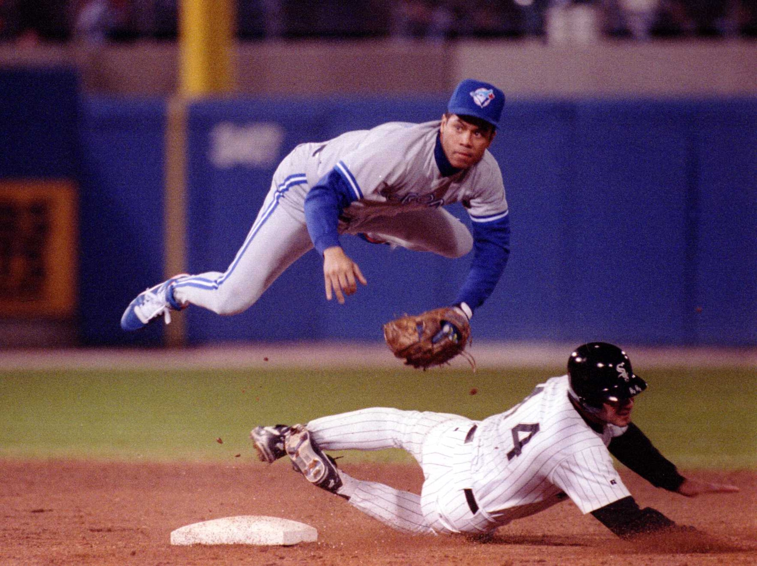 Roberto Alomar of the Toronto Blue Jays goes airbourne over Chicago White Sox Dan Pasqua to convert the double play. Mandatory Credit: Jonathan Daniel/ALLSPORT Roberto Alomar of the Toronto Blue Jays goes airbourne over Chicago White Sox Dan Pasqua to convert the double play. Mandatory Credit: Jonathan Daniel/ALLSPORT