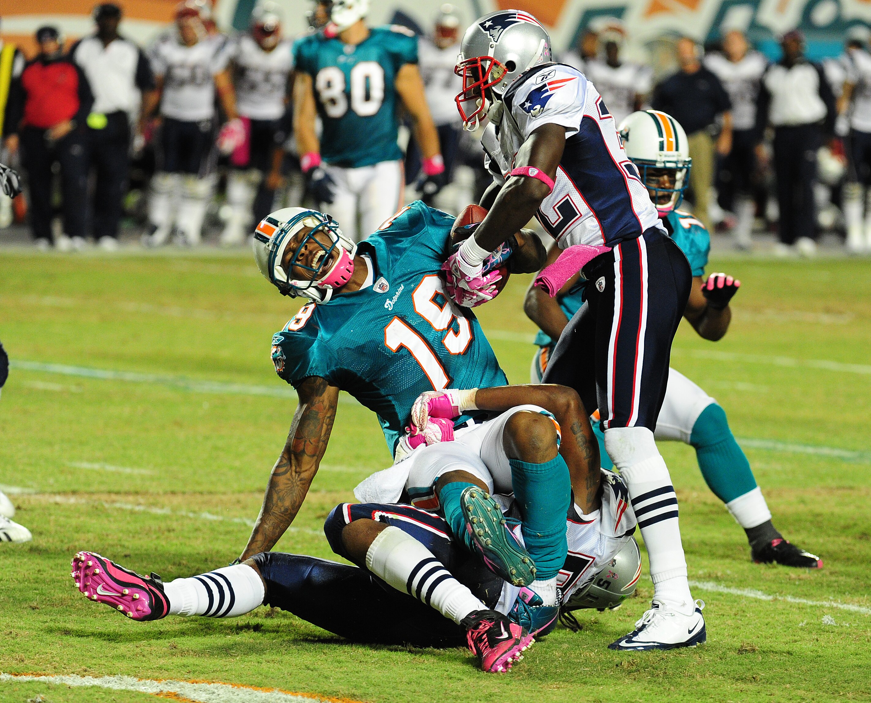 MIAMI - OCTOBER 4: Devin McCourty #32 of the New England Patriots rips the ball from Brandon Marshall #19 of the Miami Dolphins at Sun Life Field on October 4, 2010 in Miami, Florida. (Photo by Scott Cunningham/Getty Images)