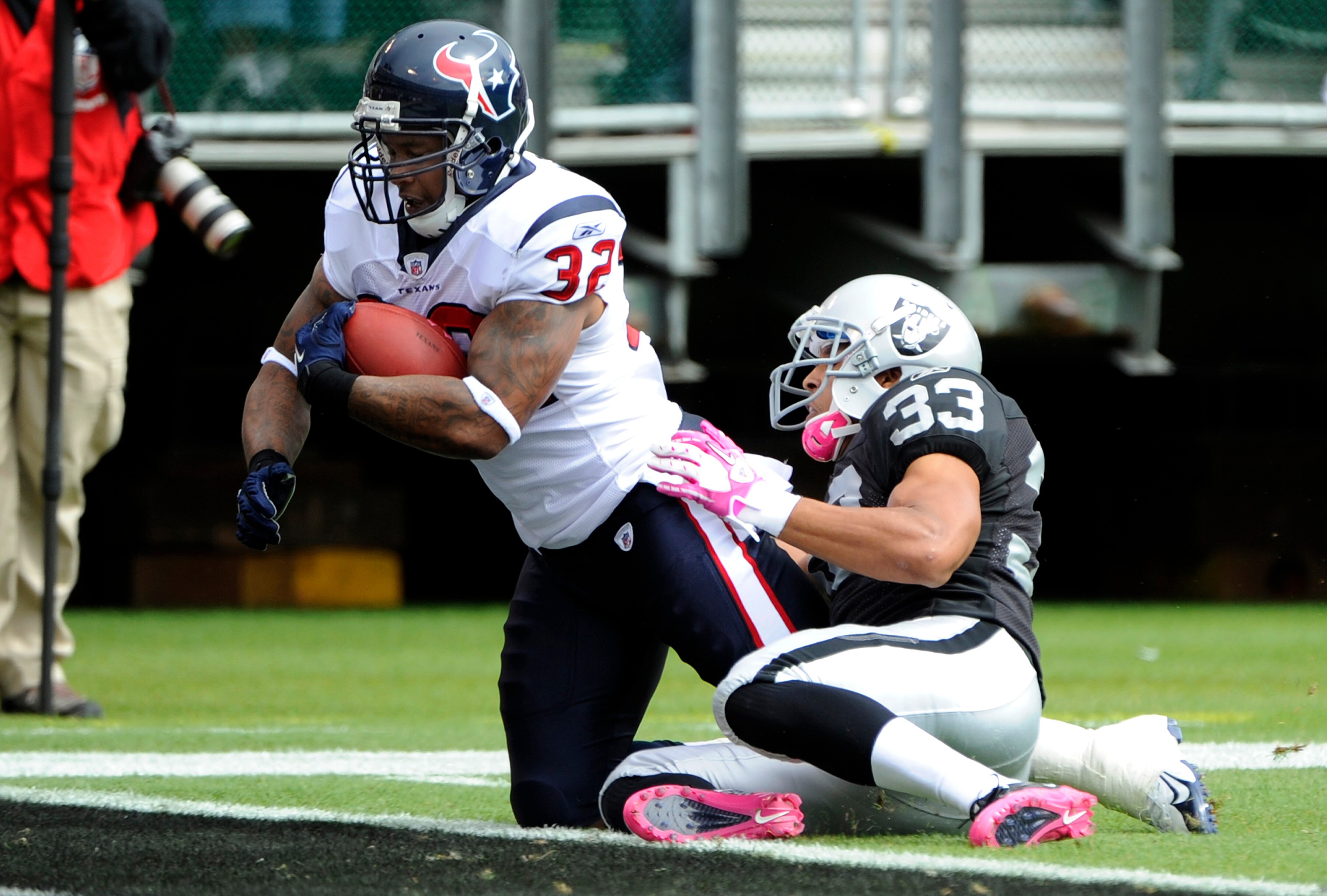 OAKLAND, CA - OCTOBER 3: Running back Derrick Ward #32 of the Houston Texans drags safety Tyvon Branch #33 of the Oakland Raiders into the endzone for a touchdown during an NFL football game October 3, 2010 at The Oakland-Alameda County Coliseum in Oaklan