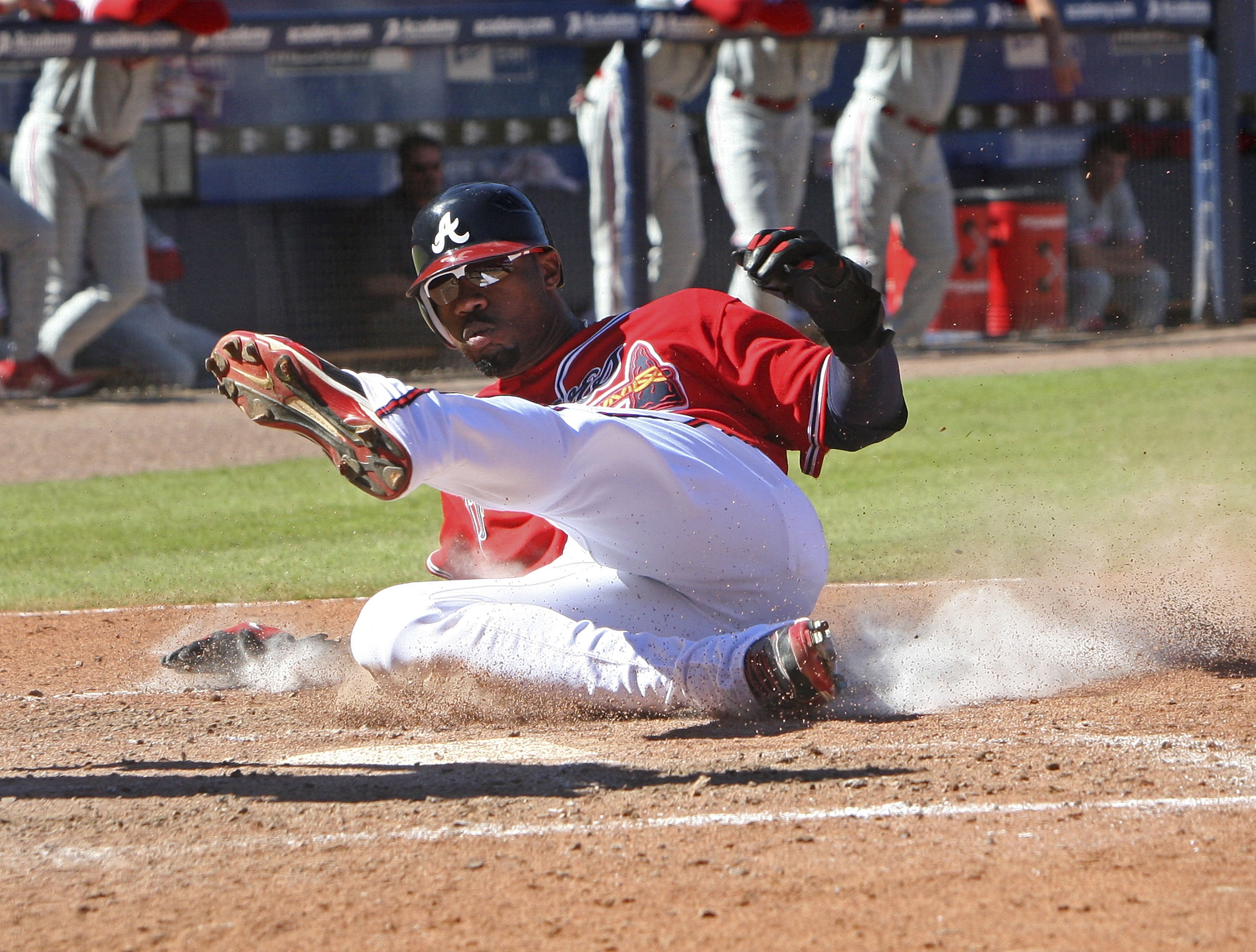 ATLANTA - OCTOBER 3:  Right fielder Jason Heyward #22 of the Atlanta Braves slides into home plate to score in the sixth inning during the game against the Philadelphia Phillies at Turner Field on October 3, 2010 in Atlanta, Georgia.  The Braves beat the